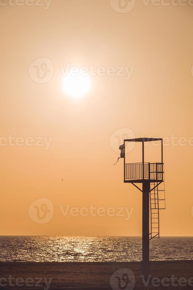 Almerimar beach lifeguard tower at sunset. Deserted beach, no people. Almeria, Andalusia, Spain photo