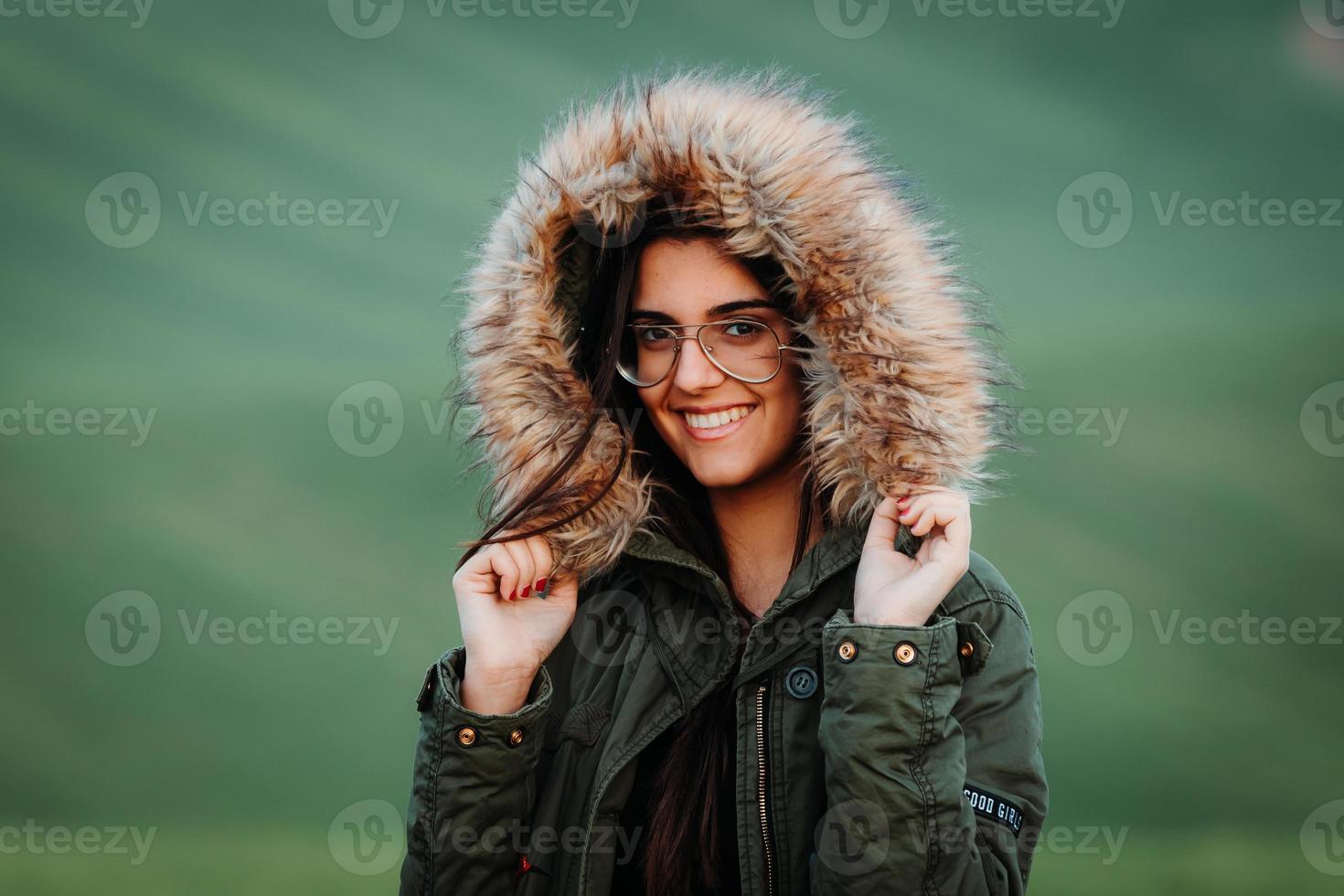 Retrato de una mujer que siente frío en invierno en la pradera verde foto