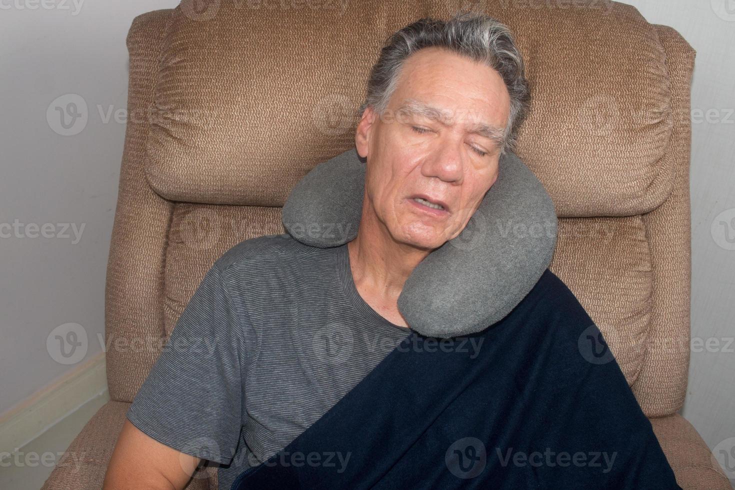 Mature Man Taking a Nap in the Middle of the Day in an Easy Chair photo