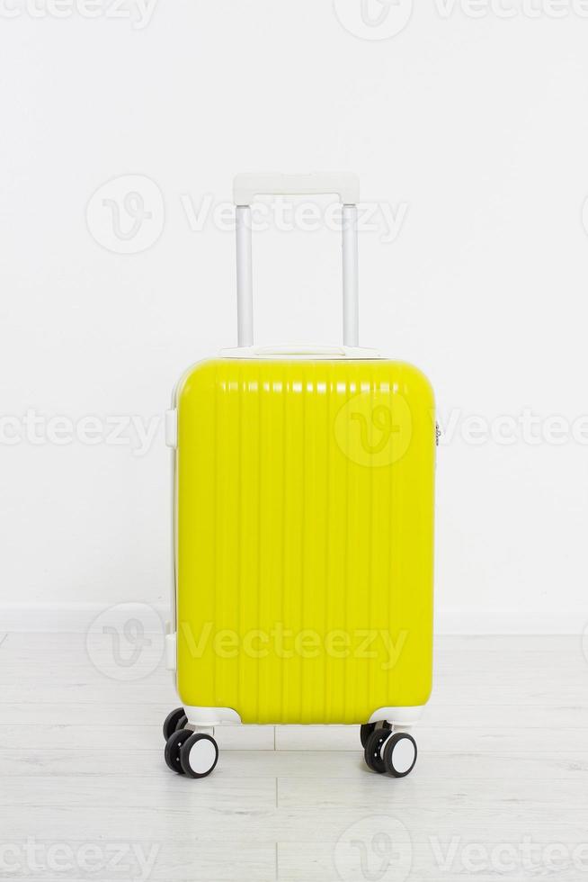 Yellow suitcase isolated on white background .Summer holidays. Travel valise or bag. Mock up. Copy space. Template. Blank. photo