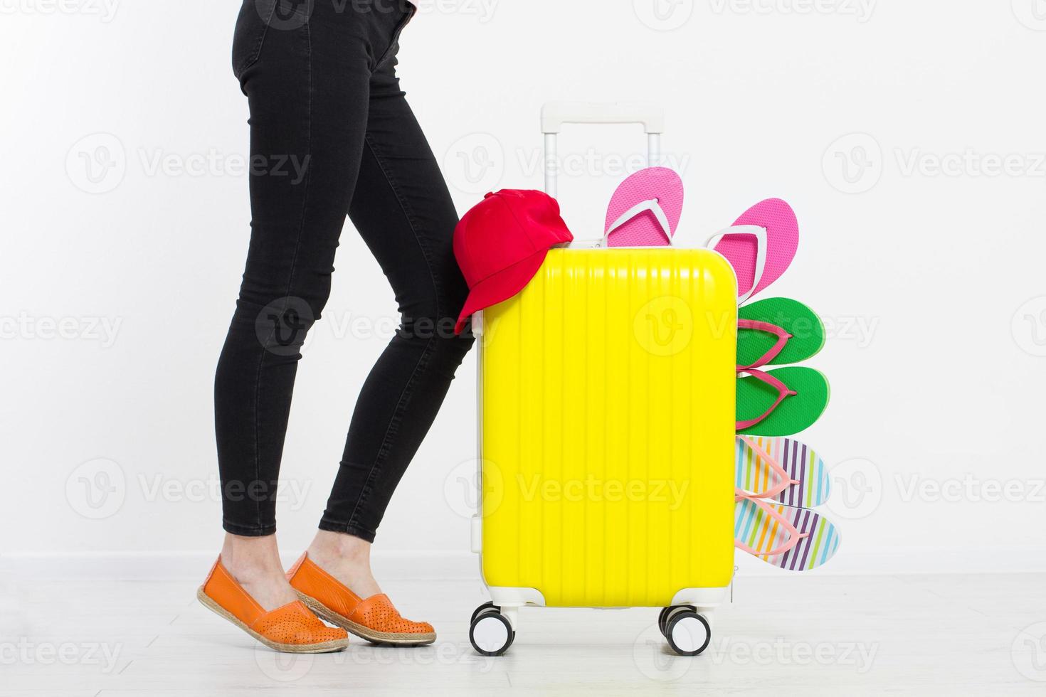 girl with suitcase isolated on white background .Summer holidays. summer flip flops or slippers. Travel valise or bag. Mock up. Copy space. Template. Blank. photo