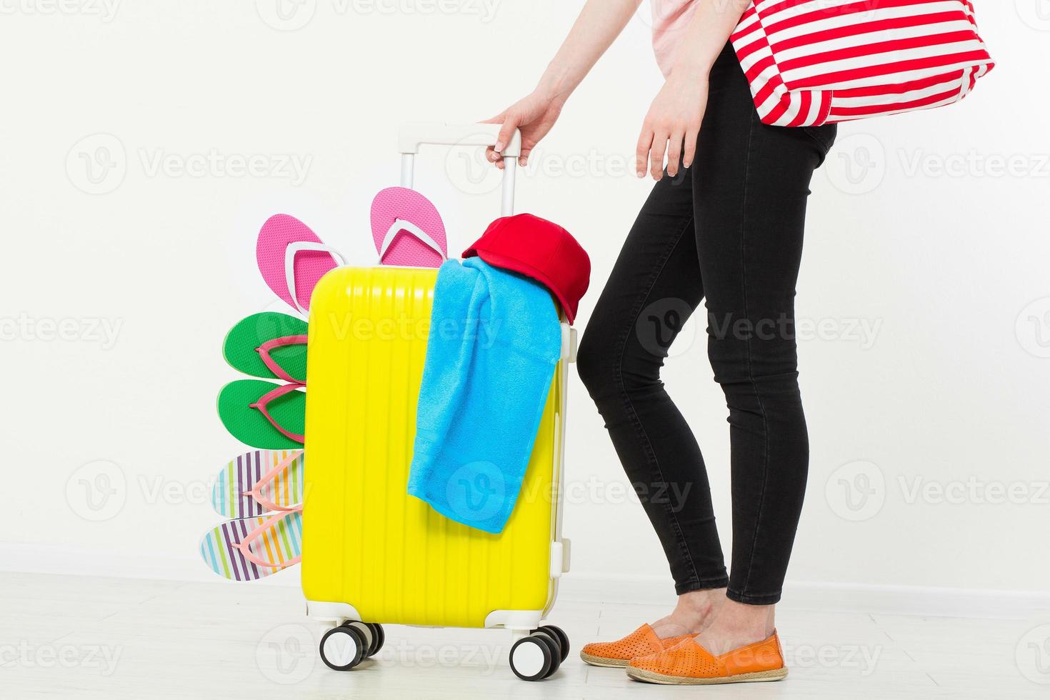 girl with suitcase isolated on white background .Summer holidays. summer flip flops or slippers. Travel valise or bag. Mock up. Copy space. Template. Blank. photo