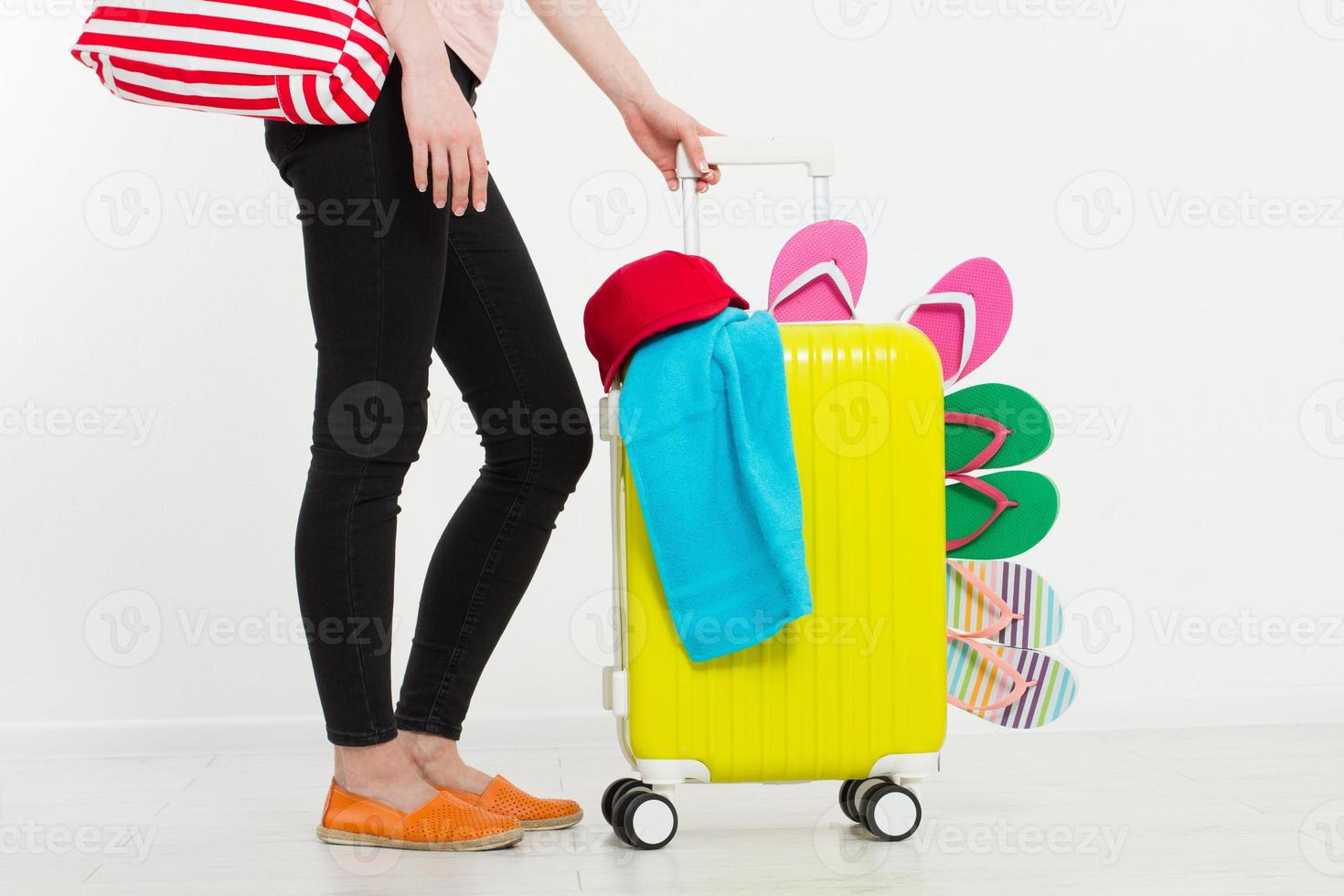 girl with suitcase isolated on white background .Summer holidays. summer flip flops or slippers. Travel valise or bag. Mock up. Copy space. Template. Blank. photo