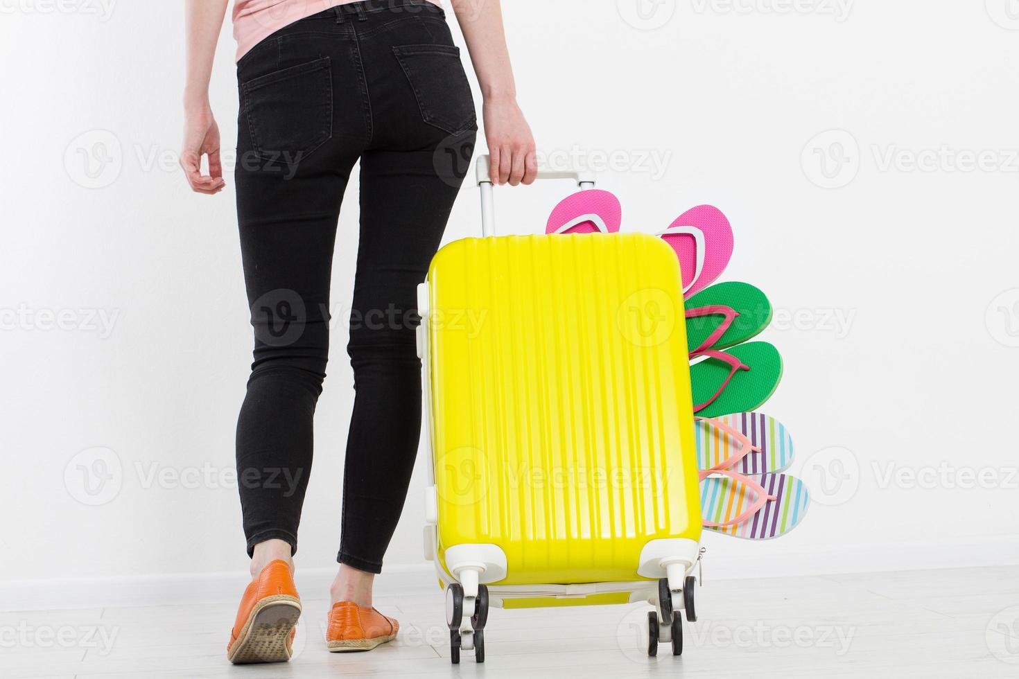 girl with suitcase isolated on white background .Summer holidays. summer flip flops or slippers. Travel valise or bag. Mock up. Copy space. Template. Blank. photo