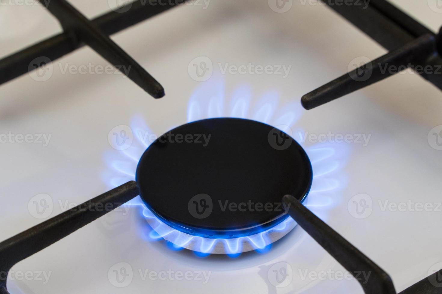 Gas burning in the burner of gas stove, gas shortage and crisis, top view photo