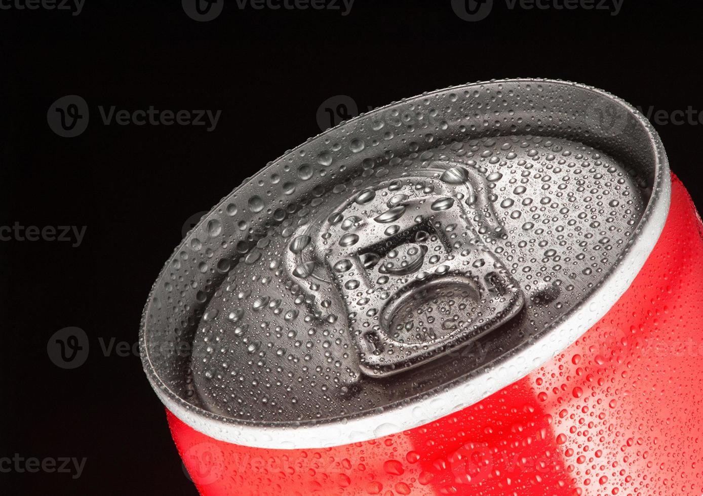 top of a red can tin with water drops close-up on a black background photo