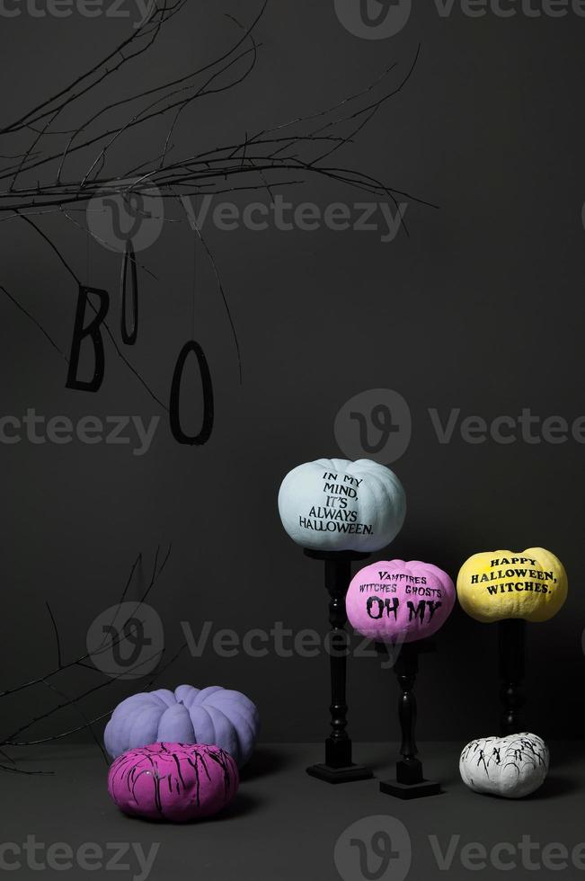 halloween with brightly painted pumpkins and tree on a dark background photo