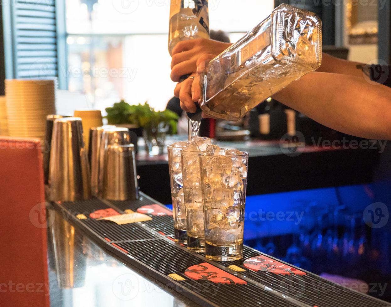 bartender preparing a cocktail with ice, close-up photo