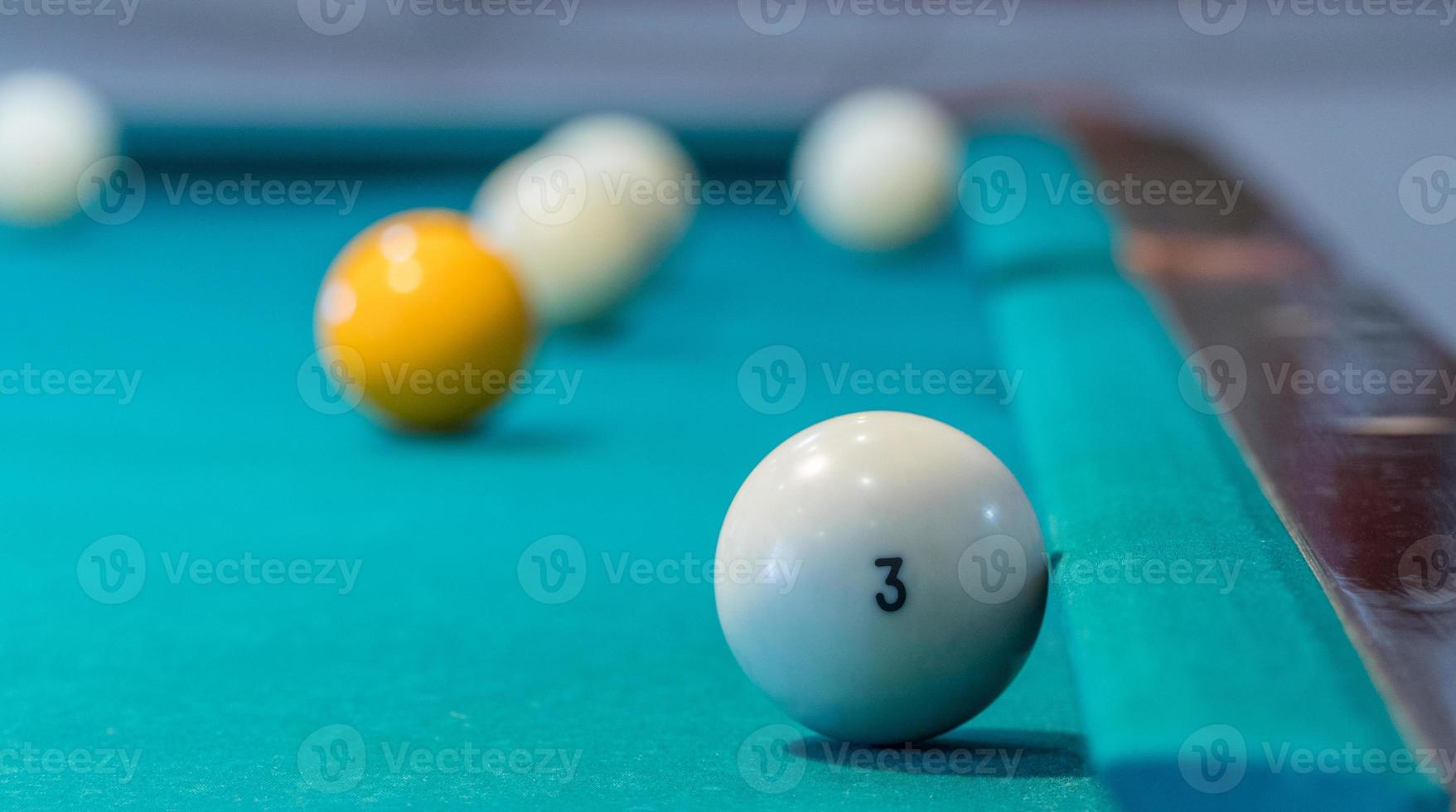 Green billiard table with white balls. Closeup photo
