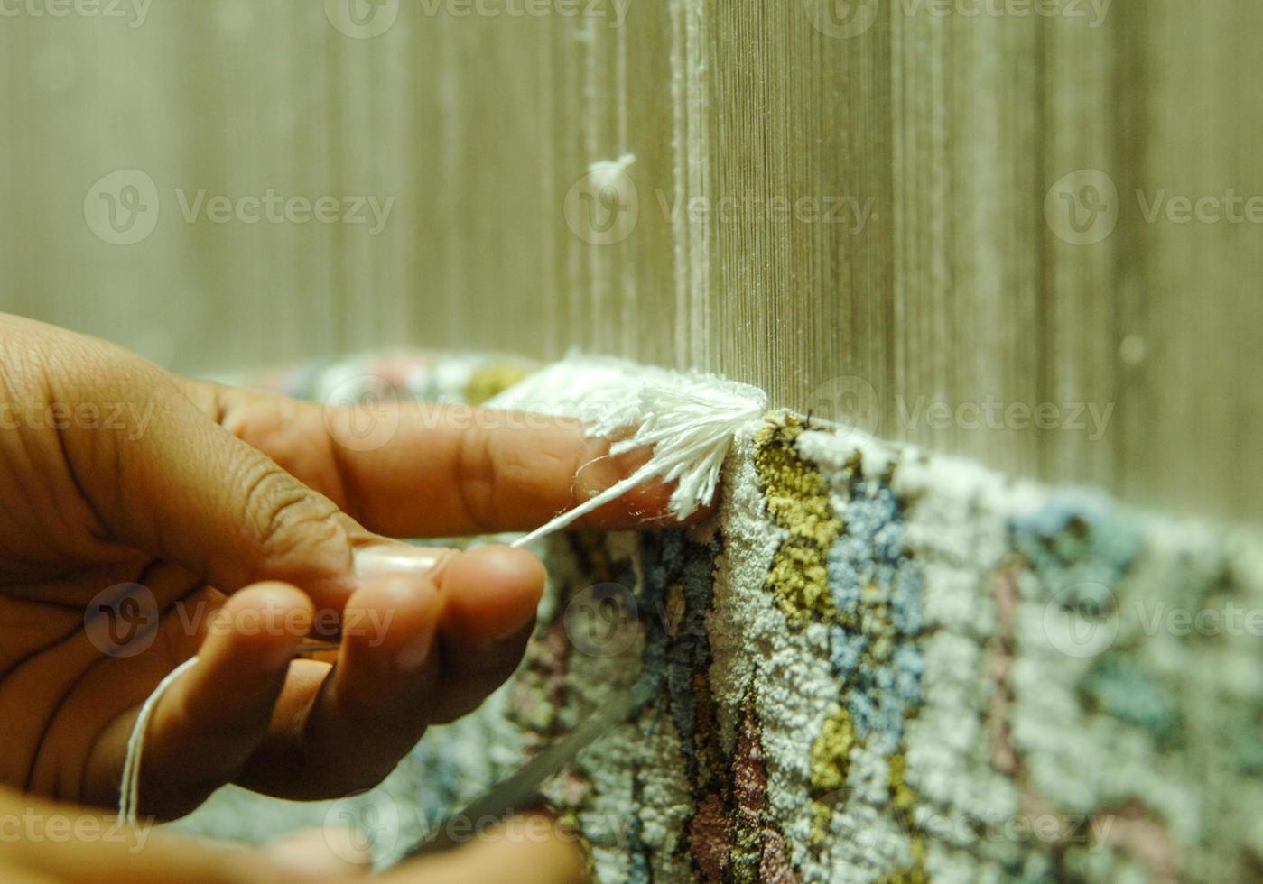 weaving and manufacturing of handmade carpets closeup photo