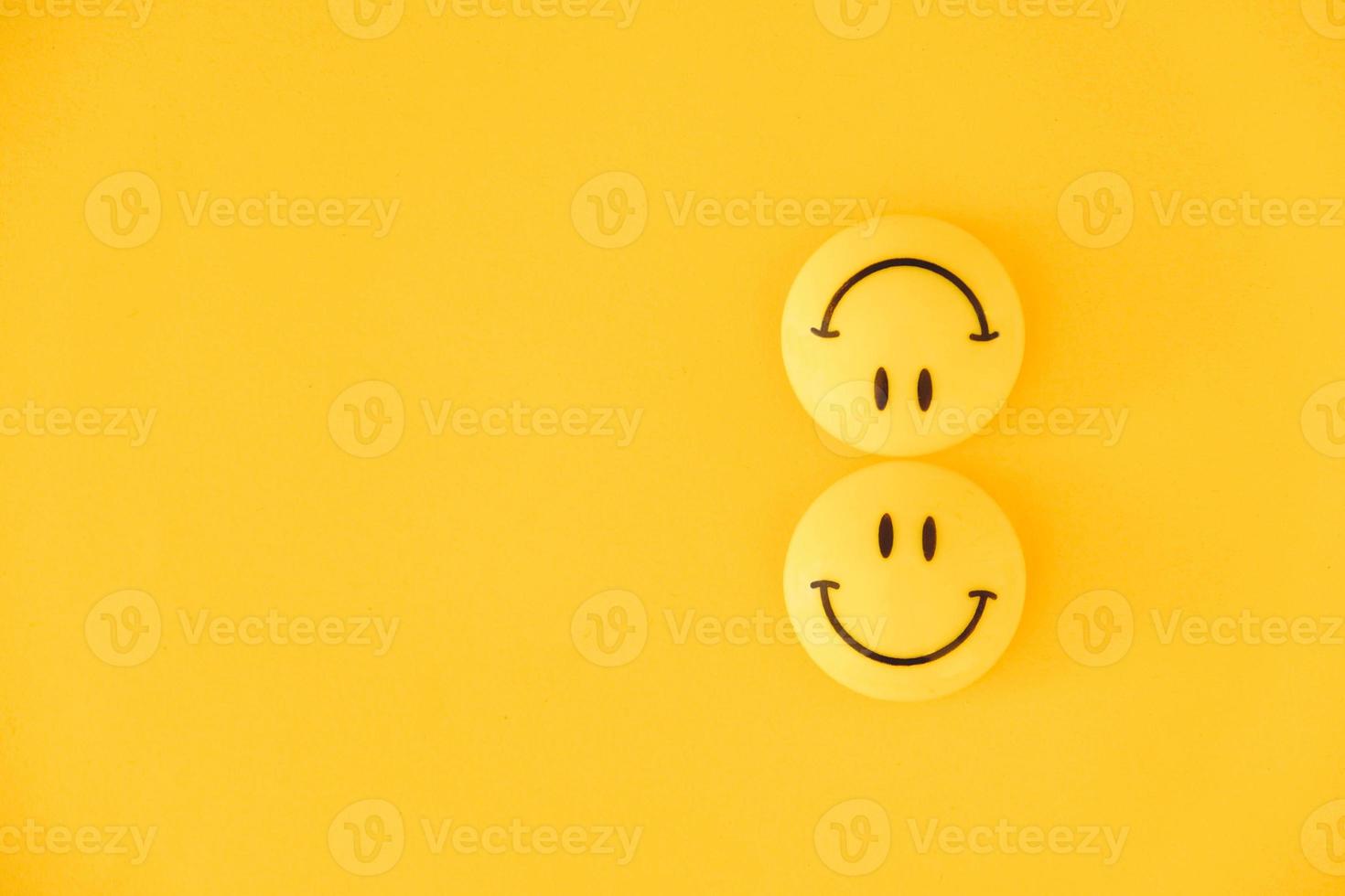 Emoticon icons funny faces on yellow background. Minimal concept photo