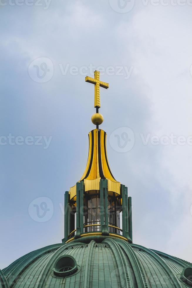 Berlin Cathedral. Close up of the cross on the top of the roof photo