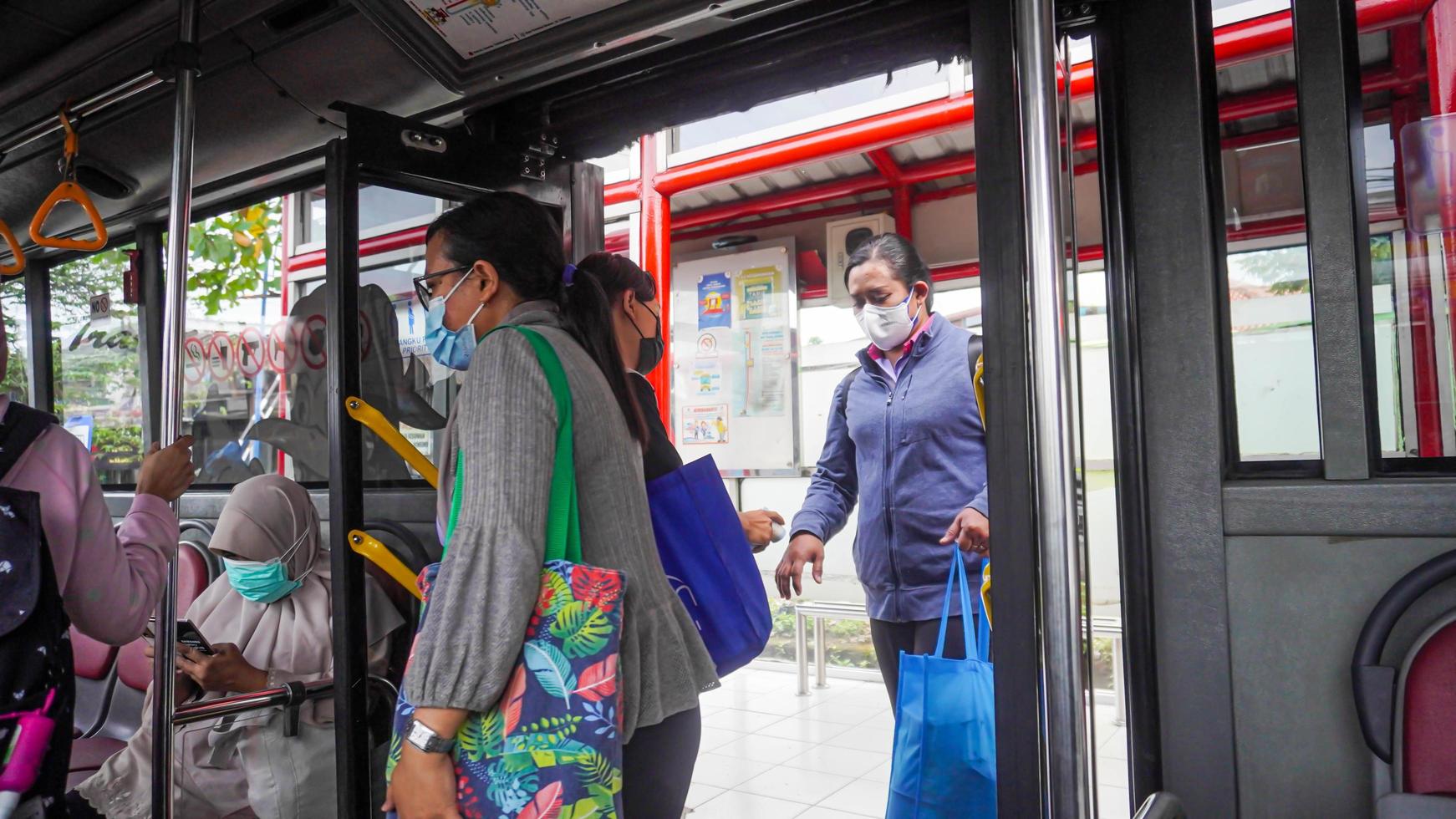 Semarang, Central Java, Indonesia, 2021 - Passengers enter the public transportation, the bus rapid transit system photo