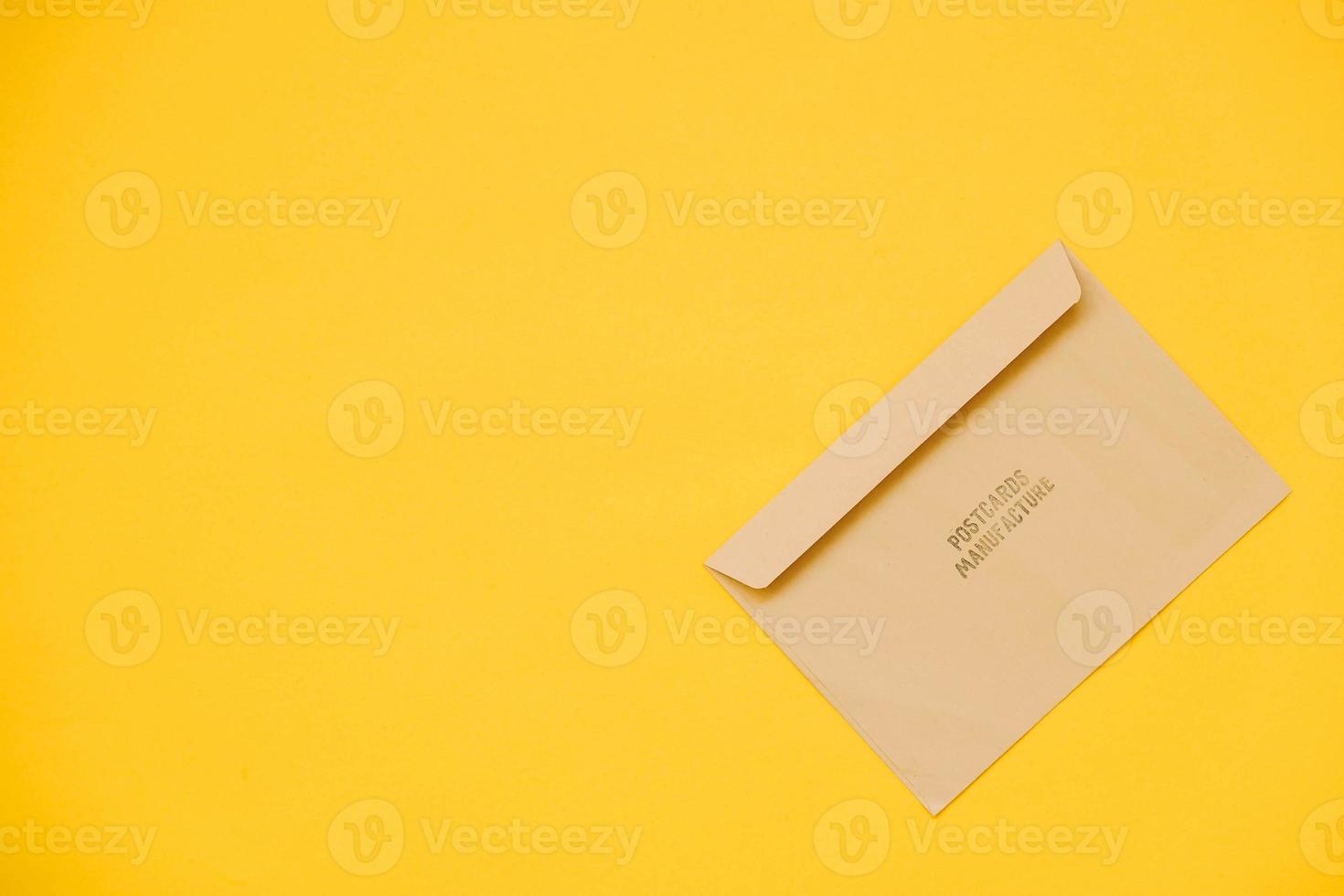 Kraft paper envelope on a yellow background photo