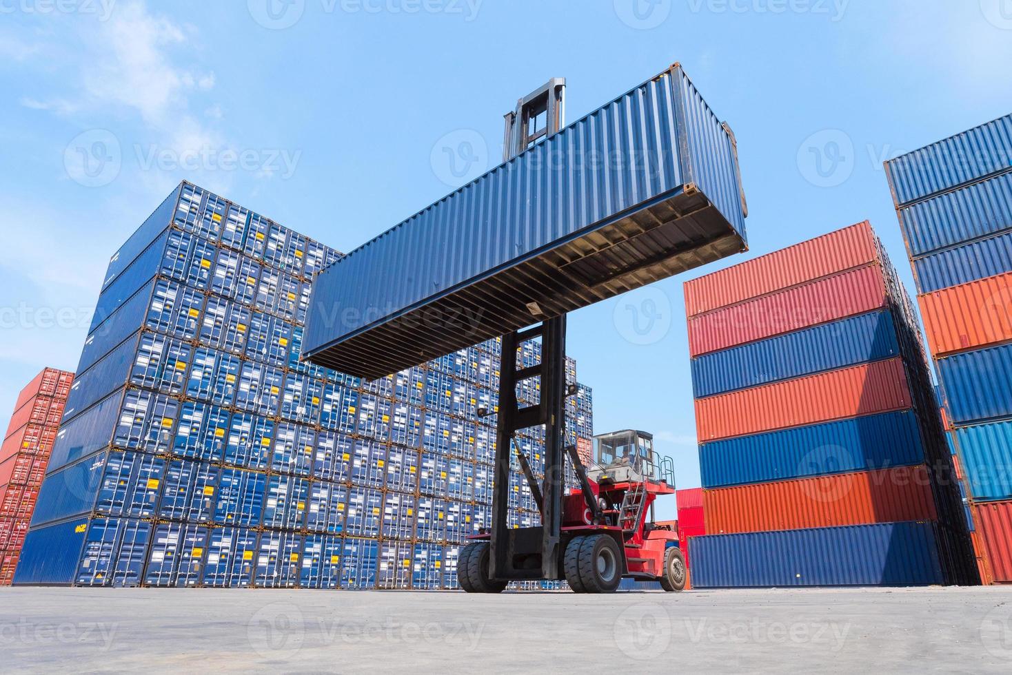 Logistic cargo container in shipping yard with cargo container stack in background. photo