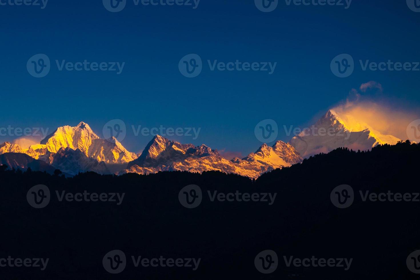 The majestic Kanchenjunga range of the himalayas at first light of sunrise at Sikkim , India photo