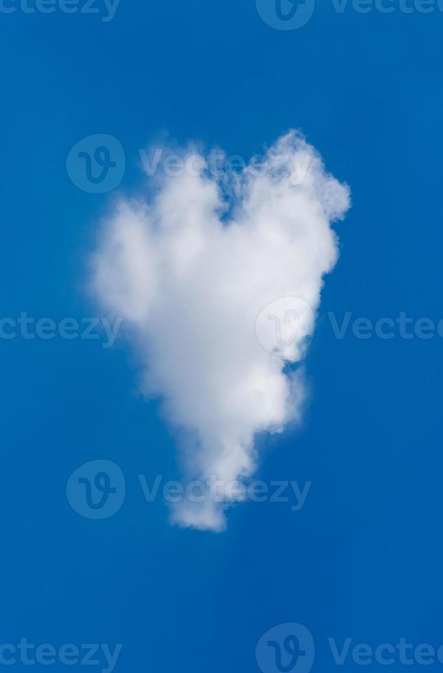 Cloud forming a heart shape on blue sky background at daytime photo