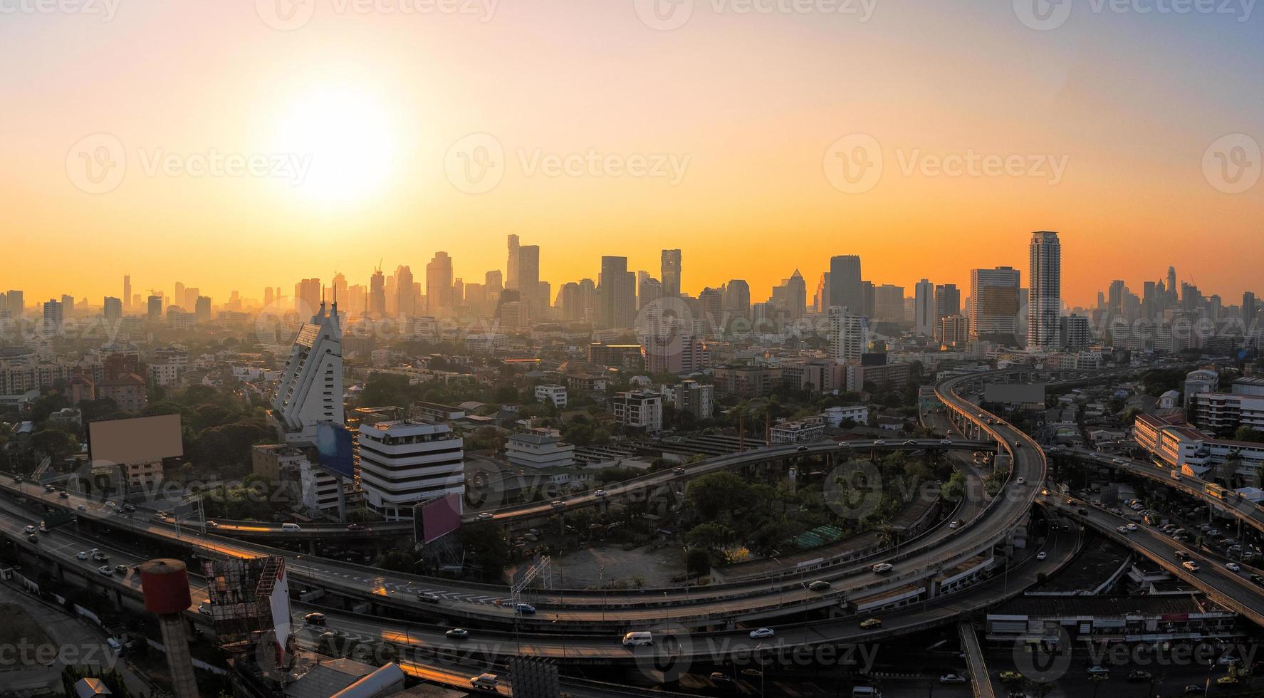 Panorama view of modern office buildings, condominium and skyscraper tower in big city downtown with sunset sky photo