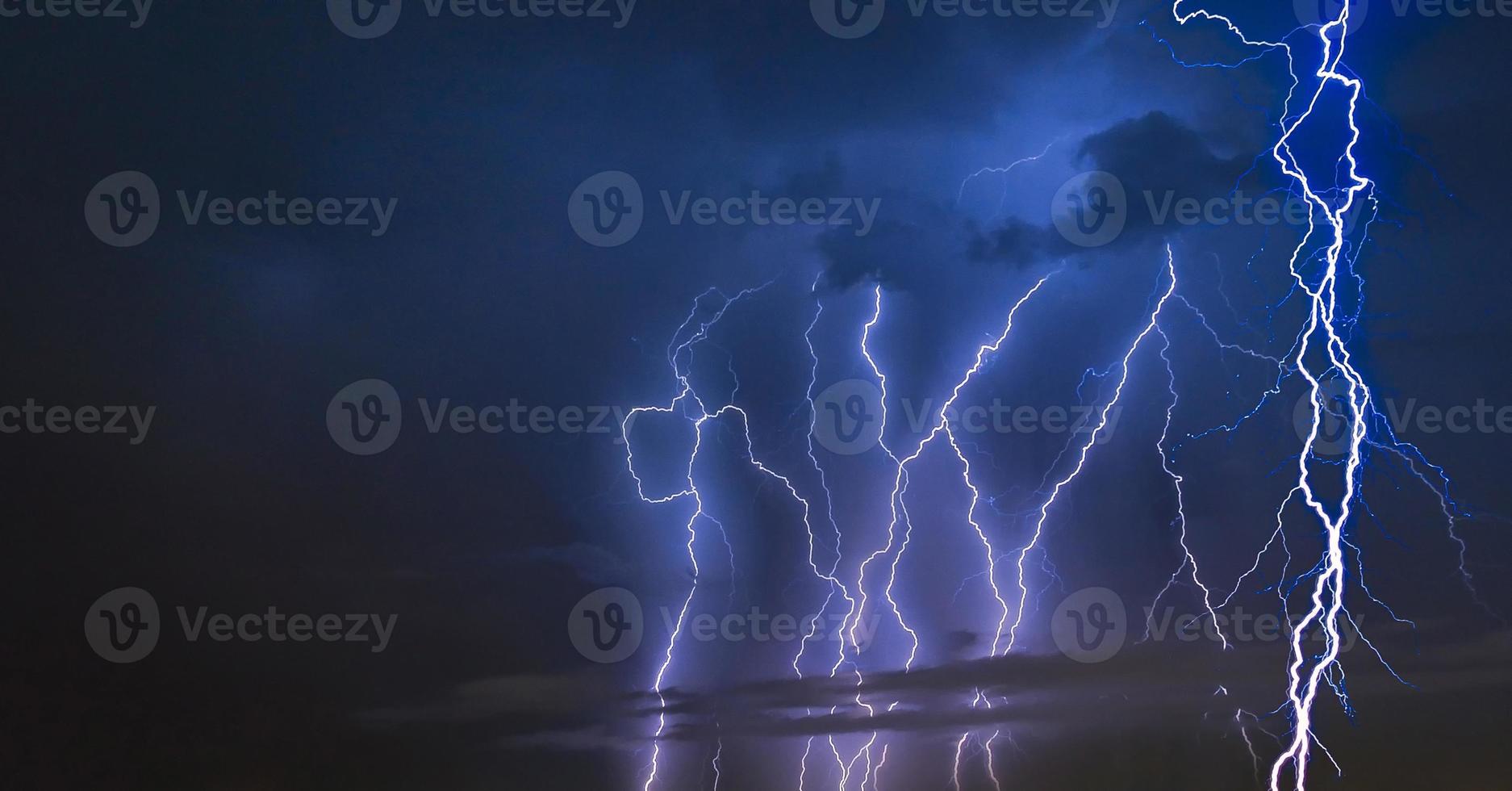 Thunder storm lightning strike on the dark cloudy sky background at night. Elegant Design with copy space for placement your text, mock up photo