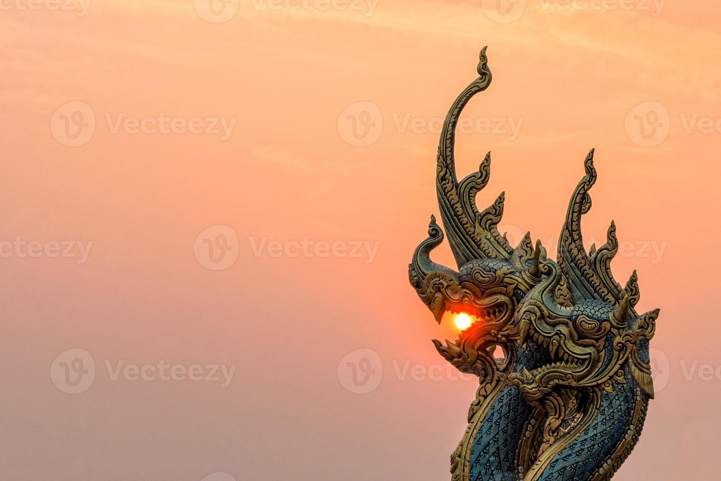 Beautiful Statue at Temple Sirindhorn Wararam Phuproud in Ubon Ratchathani Province with sunset sky, Thailand.The public temple of buddhism photo