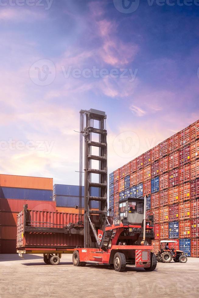 Forklift truck lifting cargo container in shipping yard or dock yard against sunrise sky with cargo container stack in background for transportation import,export and logistic industrial concept photo