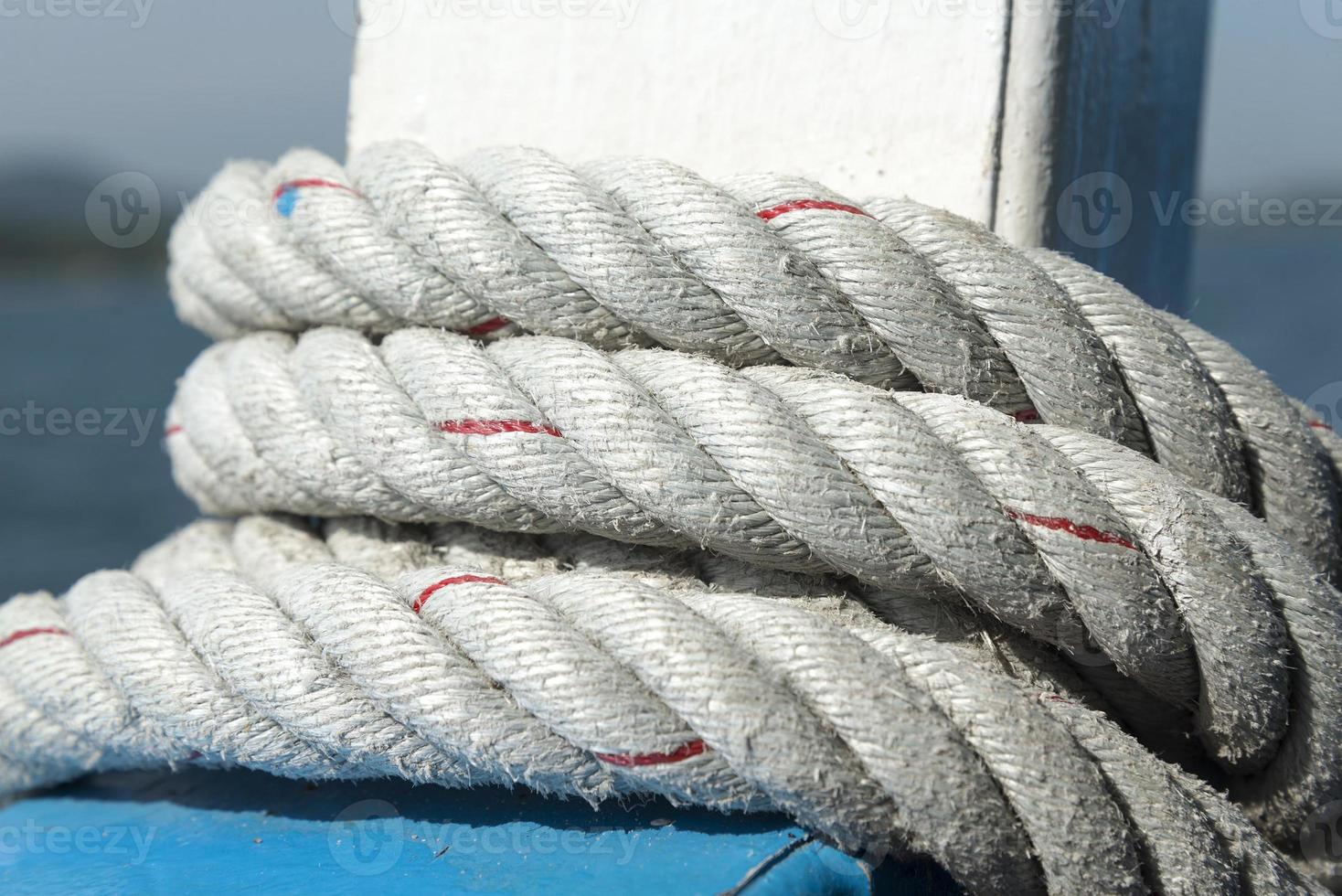 Room rope wound around the railing of the ship. photo