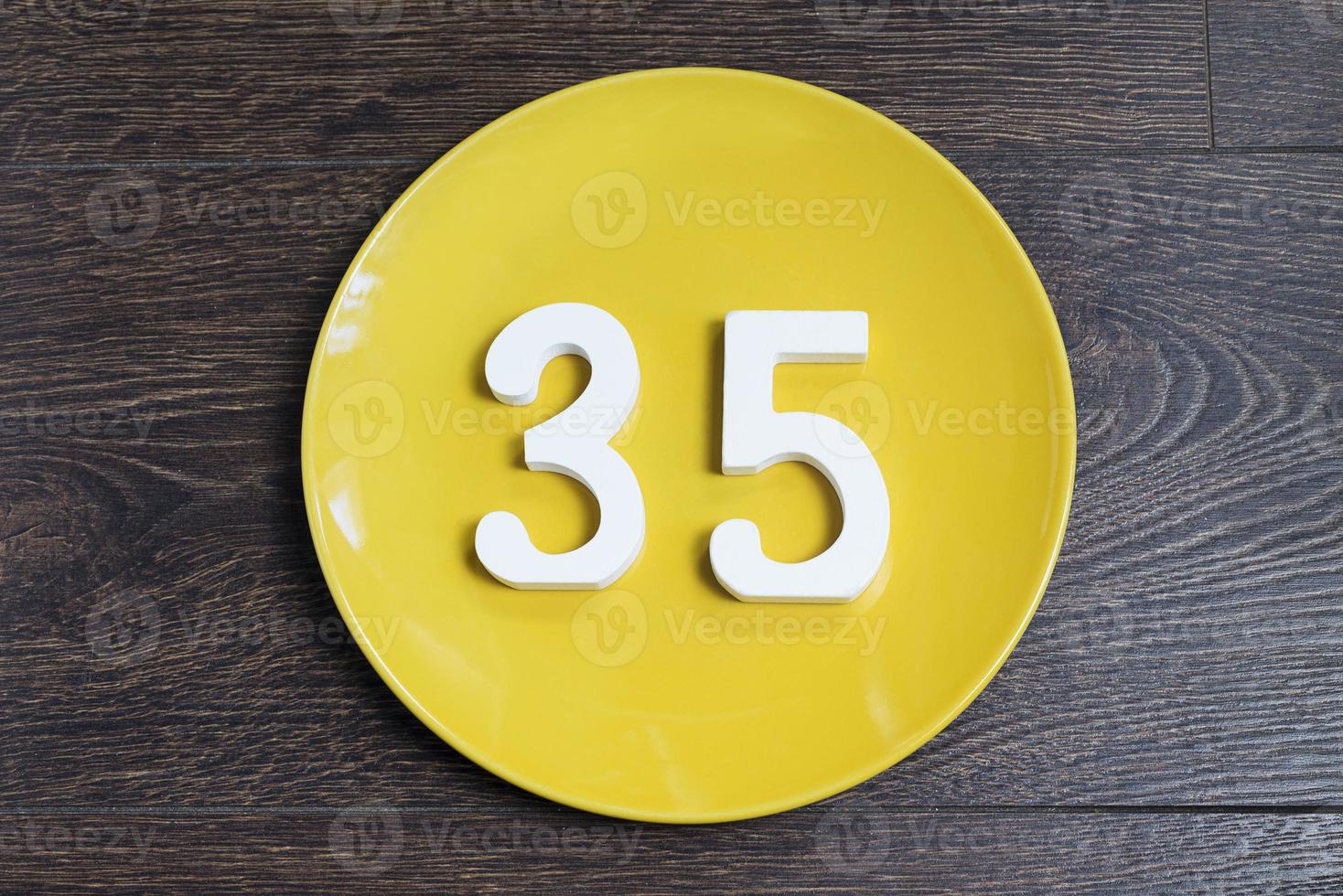 The number thirty-five on the yellow plate. photo
