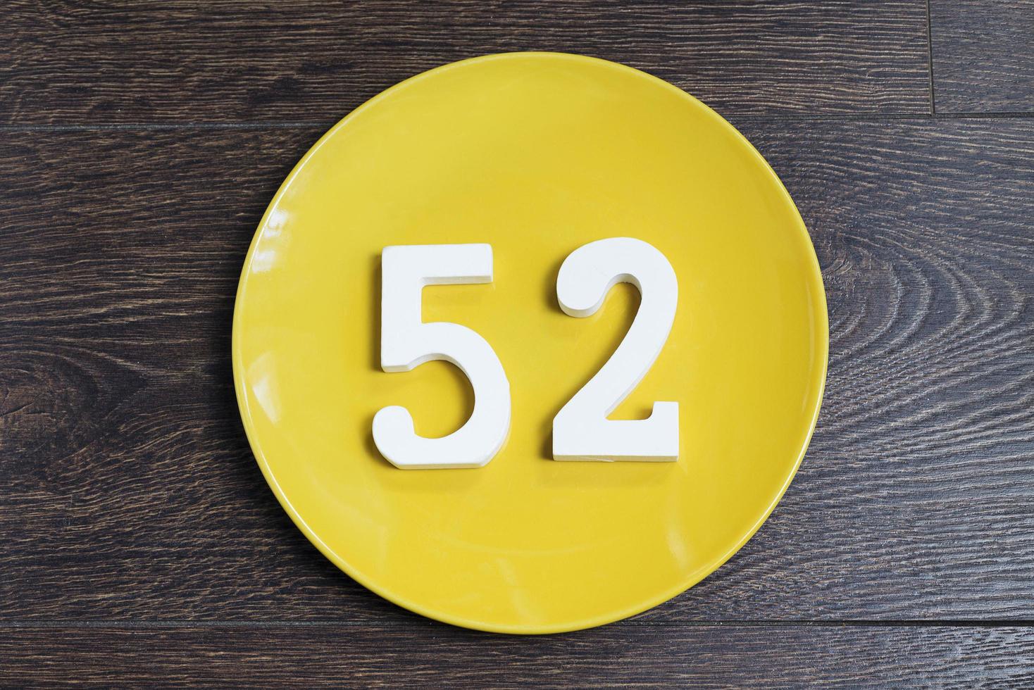 The number fifty-two on the yellow plate. photo