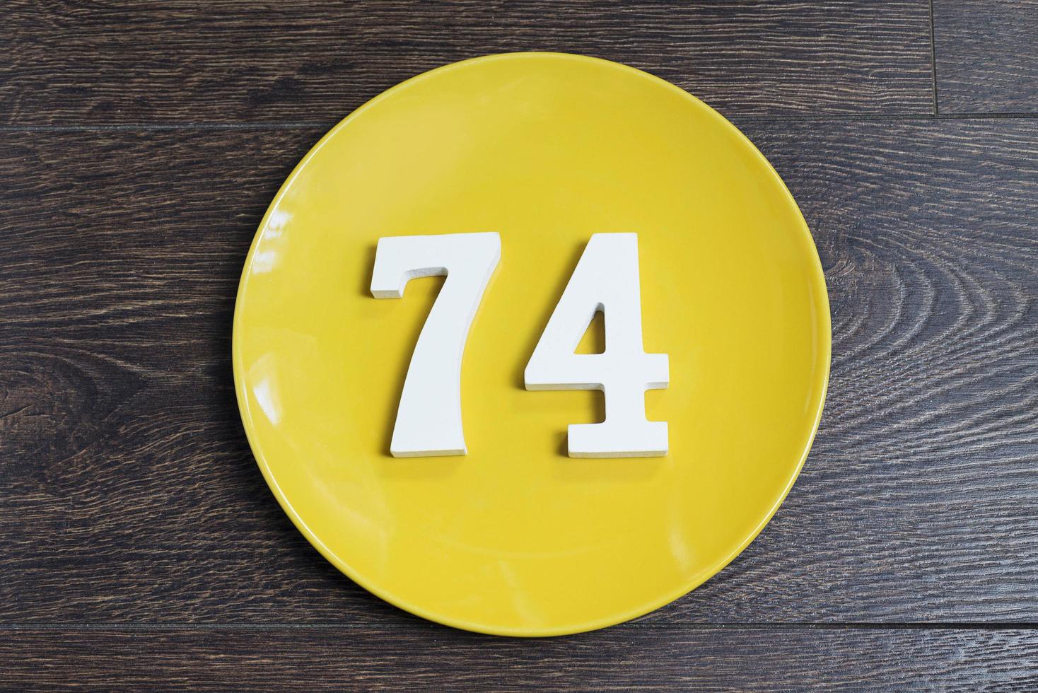 The number seventy-four on the yellow plate. photo