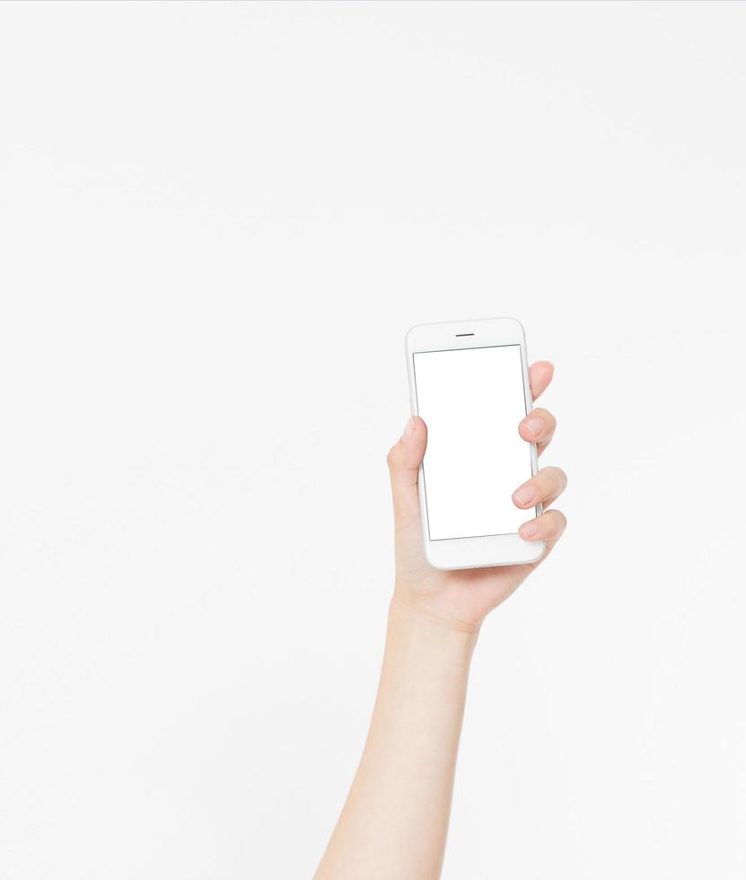 Hand holding white phone isolated on white clipping path inside. Top view.Mock up.Copy space.Template.Blank. photo