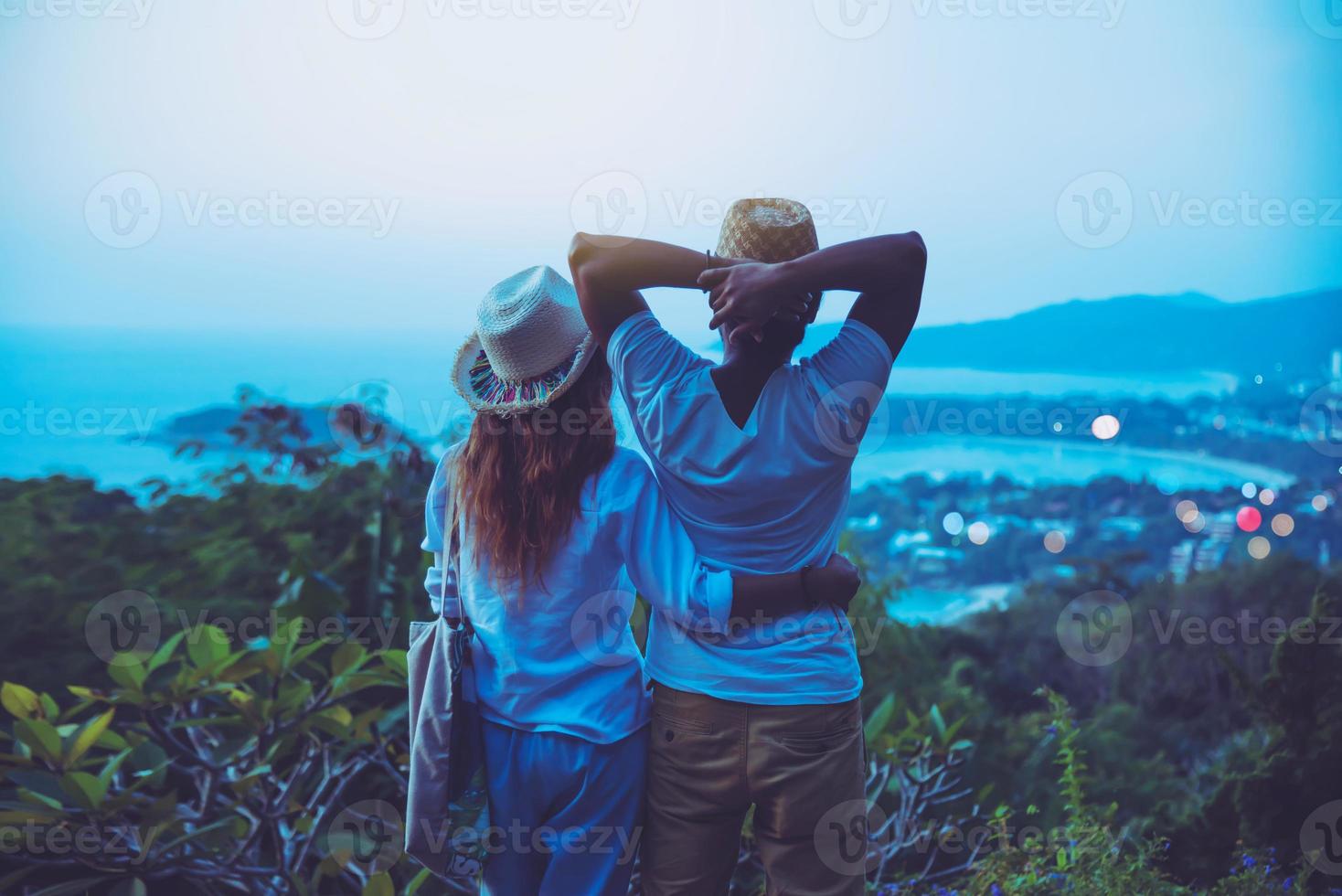 Middle aged Happy Romantic couple travel relax the beach in the holiday and standing watching the sunset. in summer photo