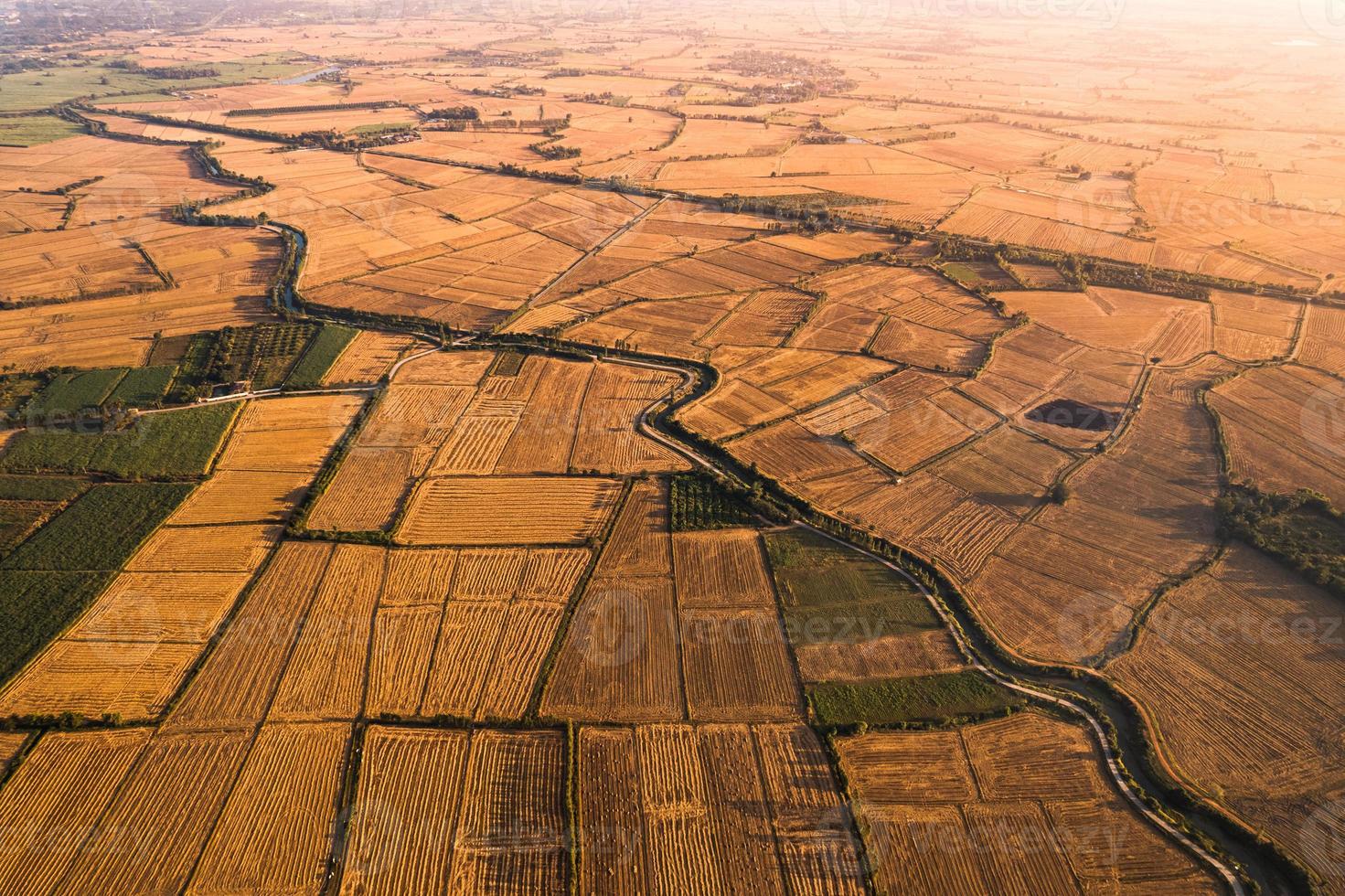 Agricultural barren fields with irrigation canal in farmland at