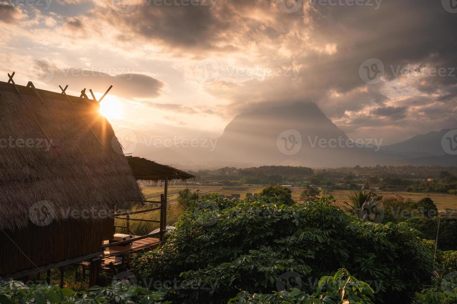 Sunset over wooden hut and Doi Luang Chiang Dao mountain view at Chiang Dao photo
