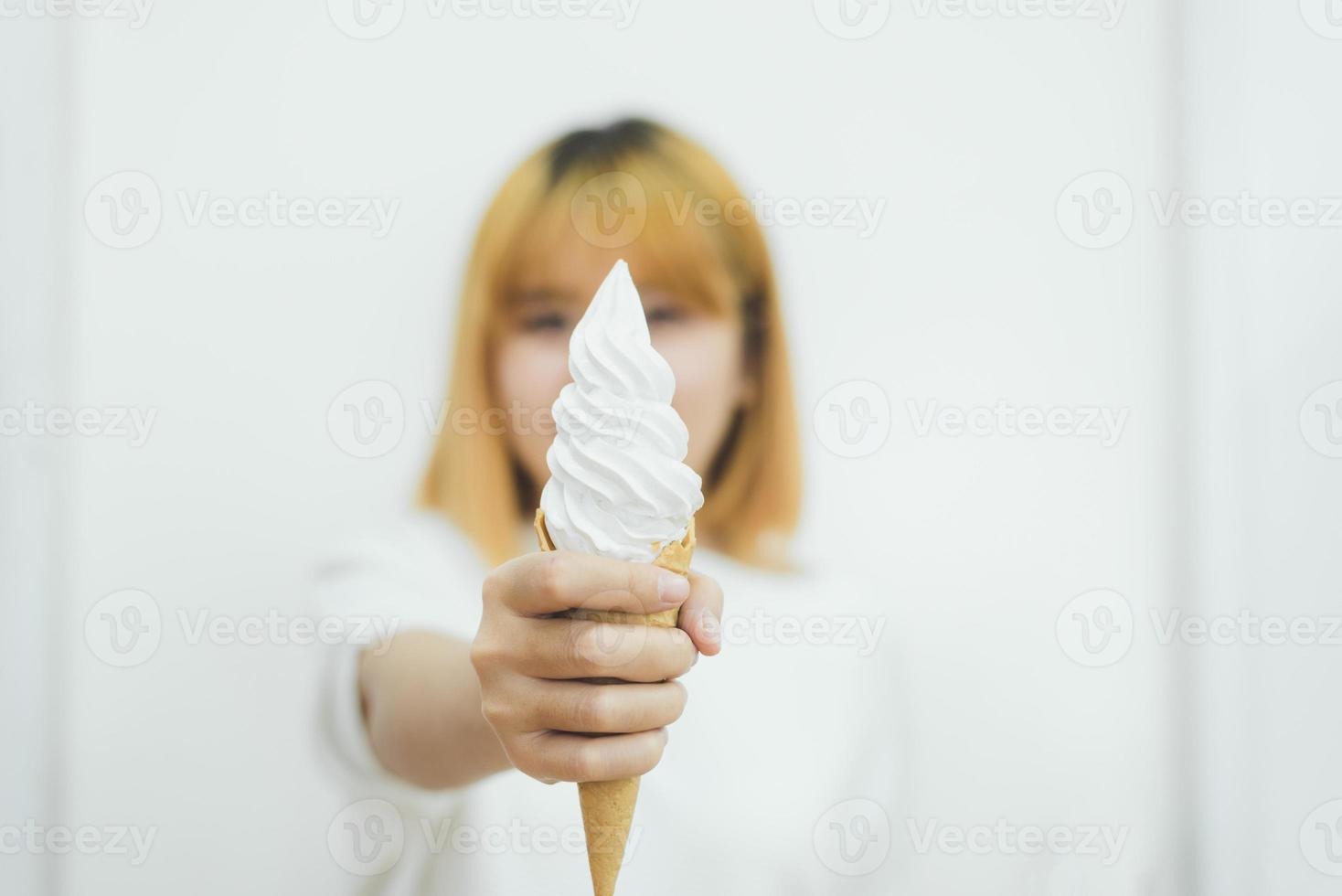 Indoor portrait of young beautiful asian woman eating ice cream in summer. Woman hands holding melting ice cream waffle cone. lifestyle asia woman concept photo