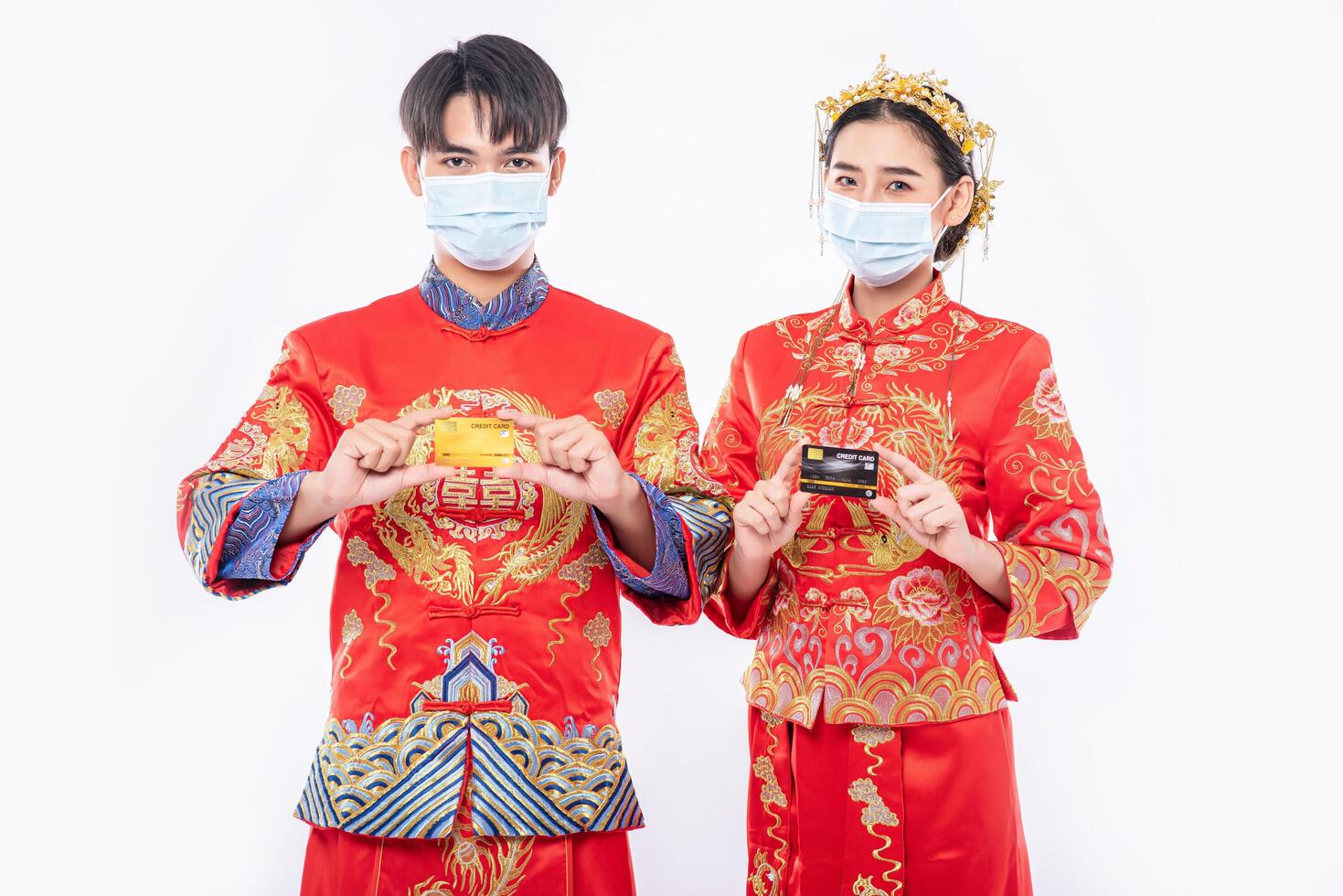 Men and women wearing qipao and face masks go shopping with credit cards. photo