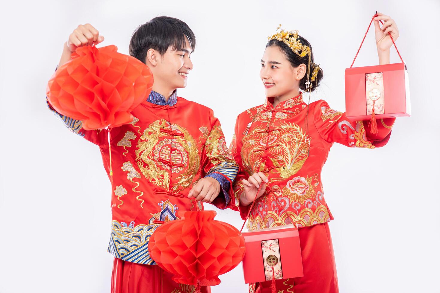 Men and women wearing cheongsam Standing holding red bag and honeycomb lantern photo