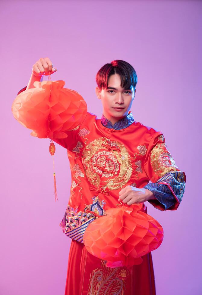 Man wear Cheongsam show decorate red lamp to  shop in chinese new year photo