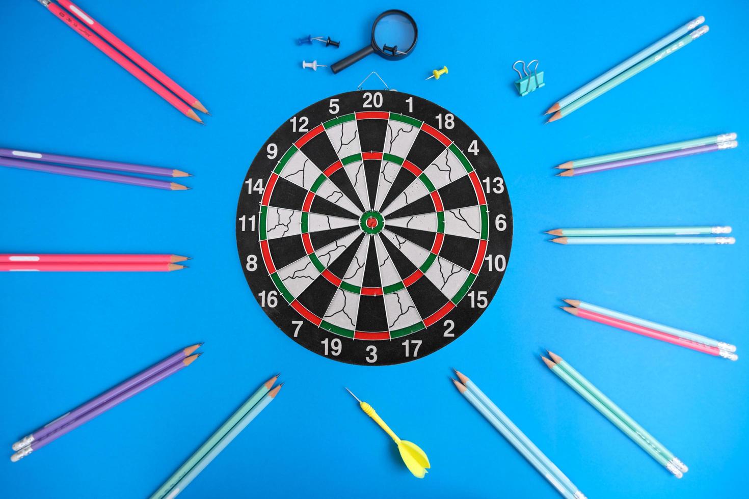 Dart board and a desk. Workspace with a target and a successful business growth concept, as well as a dart board with a target. photo