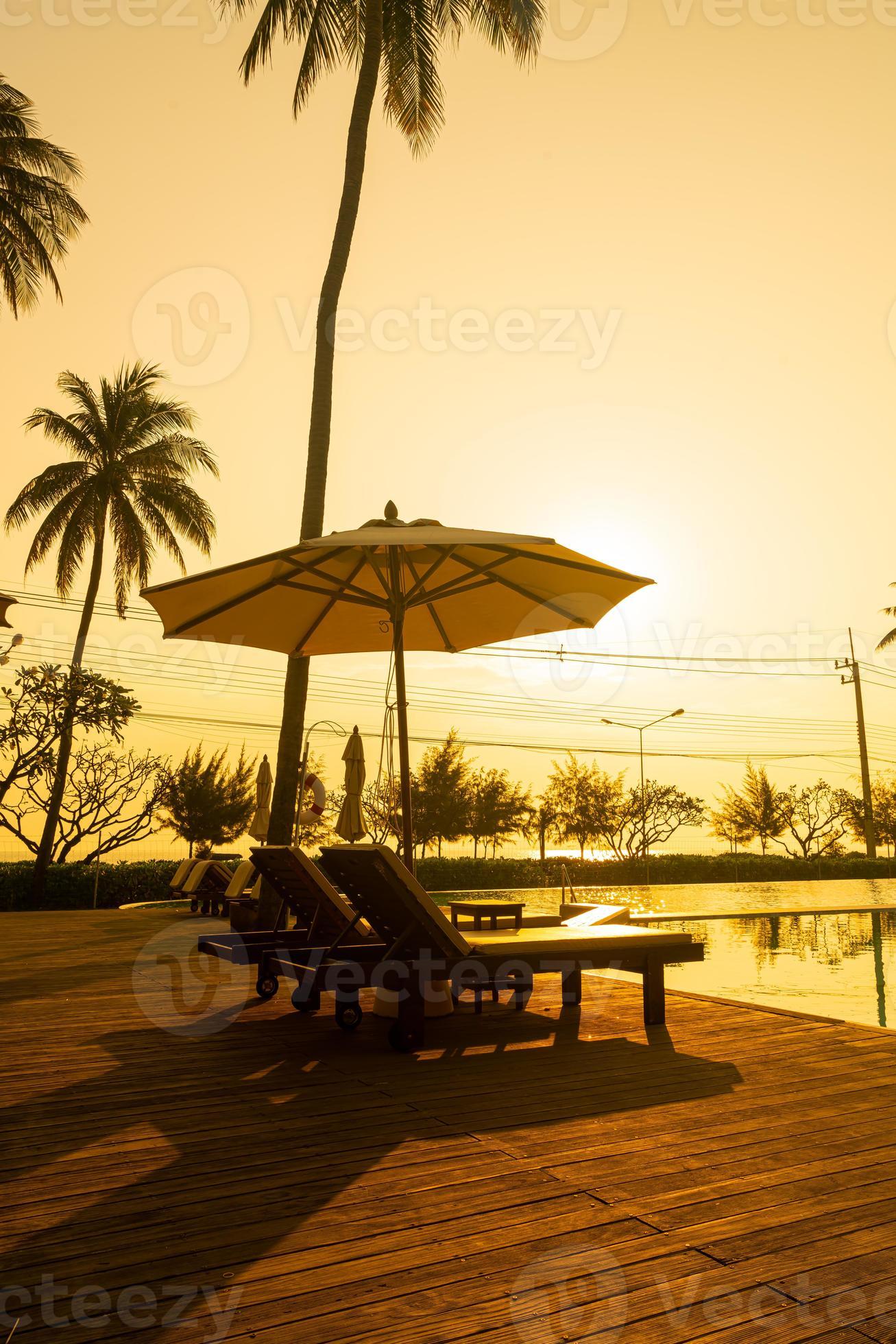 umbrella with bed pool around swimming pool with ocean sea background