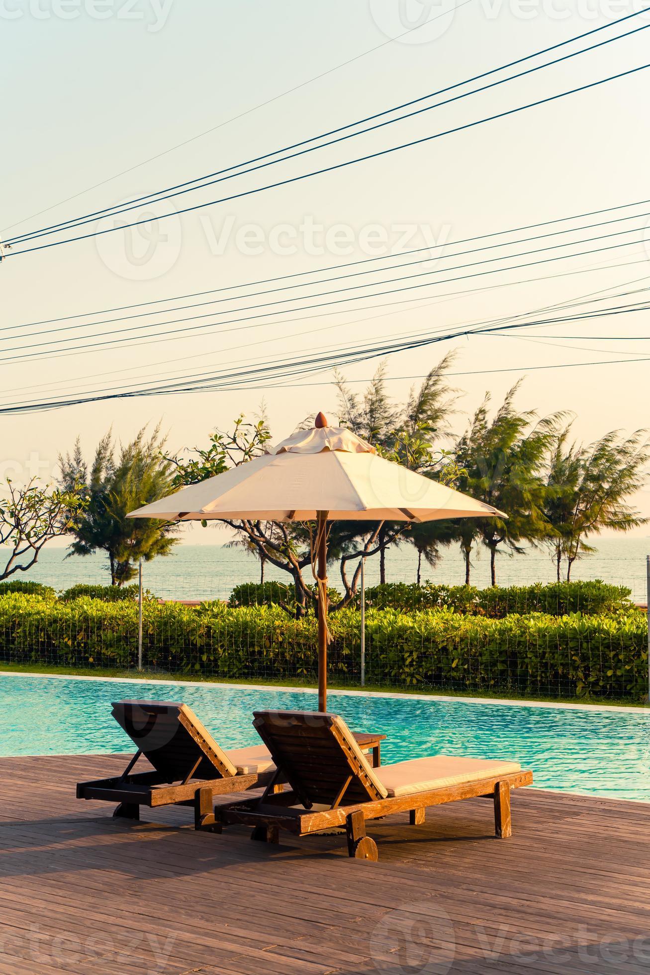 umbrella with bed pool around swimming pool with ocean sea background