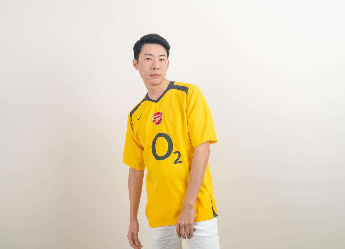 Bangkok, THAILAND - Nov 27, 2021 - Young Asian man wearing Arsenal shirt with white background. photo