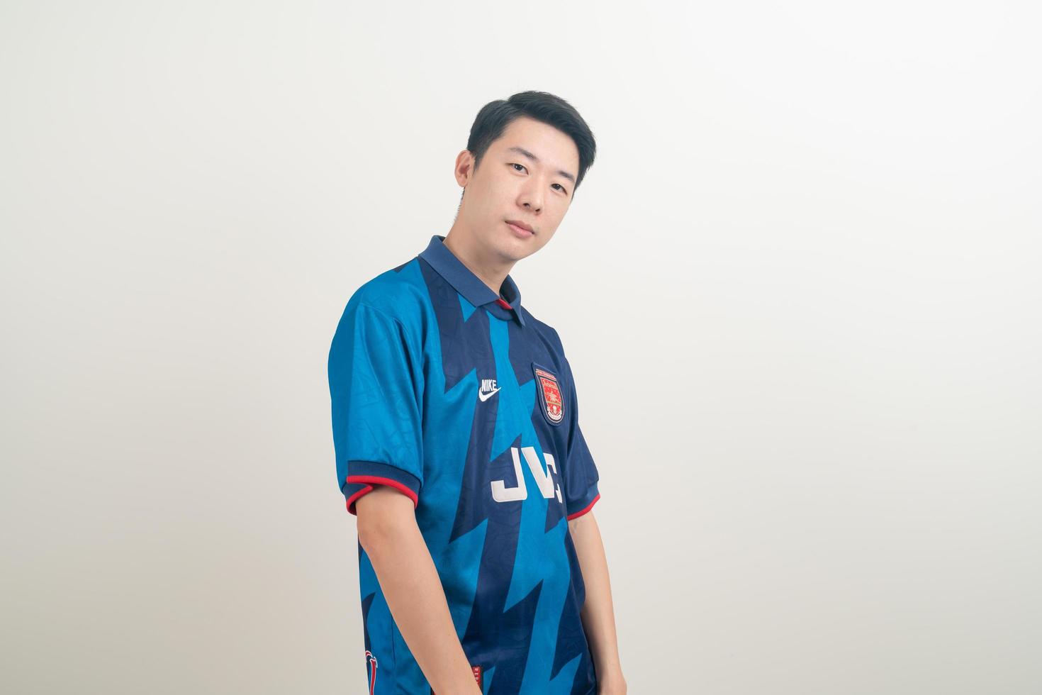 Bangkok, THAILAND - Nov 27, 2021 - Young Asian man wearing Arsenal shirt with white background. photo