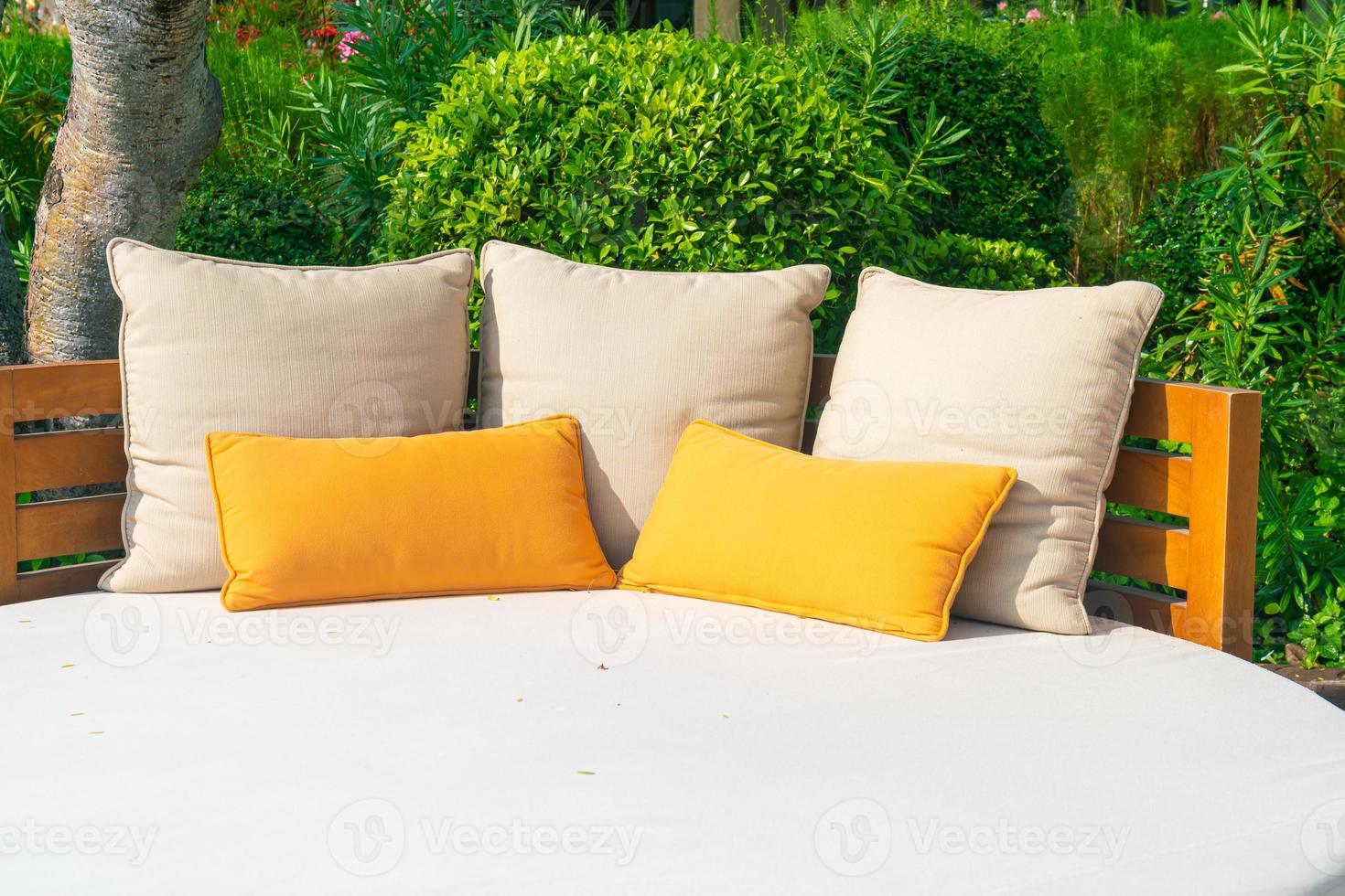 pillows on outdoor patio chair with umbrella photo