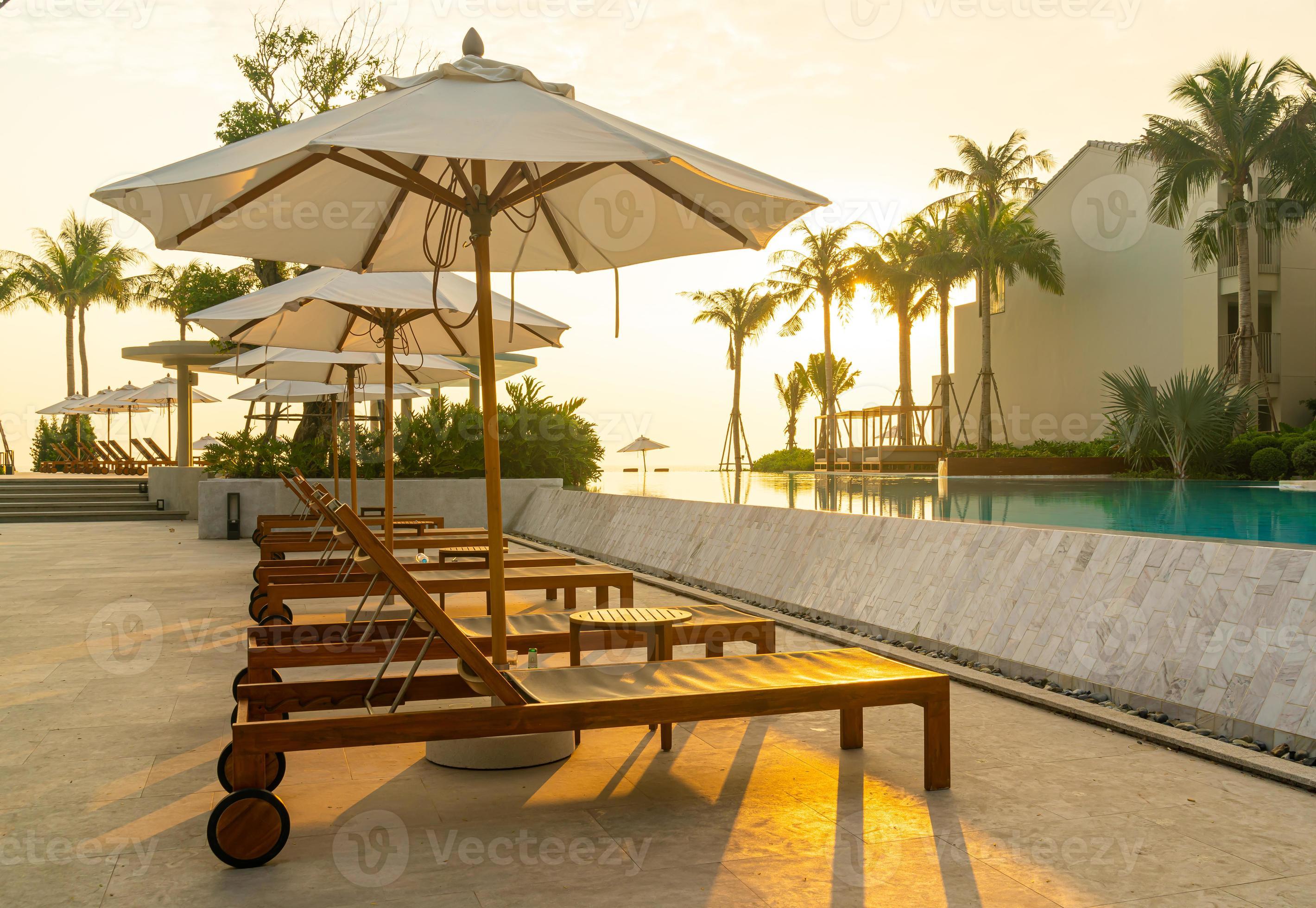 umbrella with bed pool around swimming pool with ocean sea background