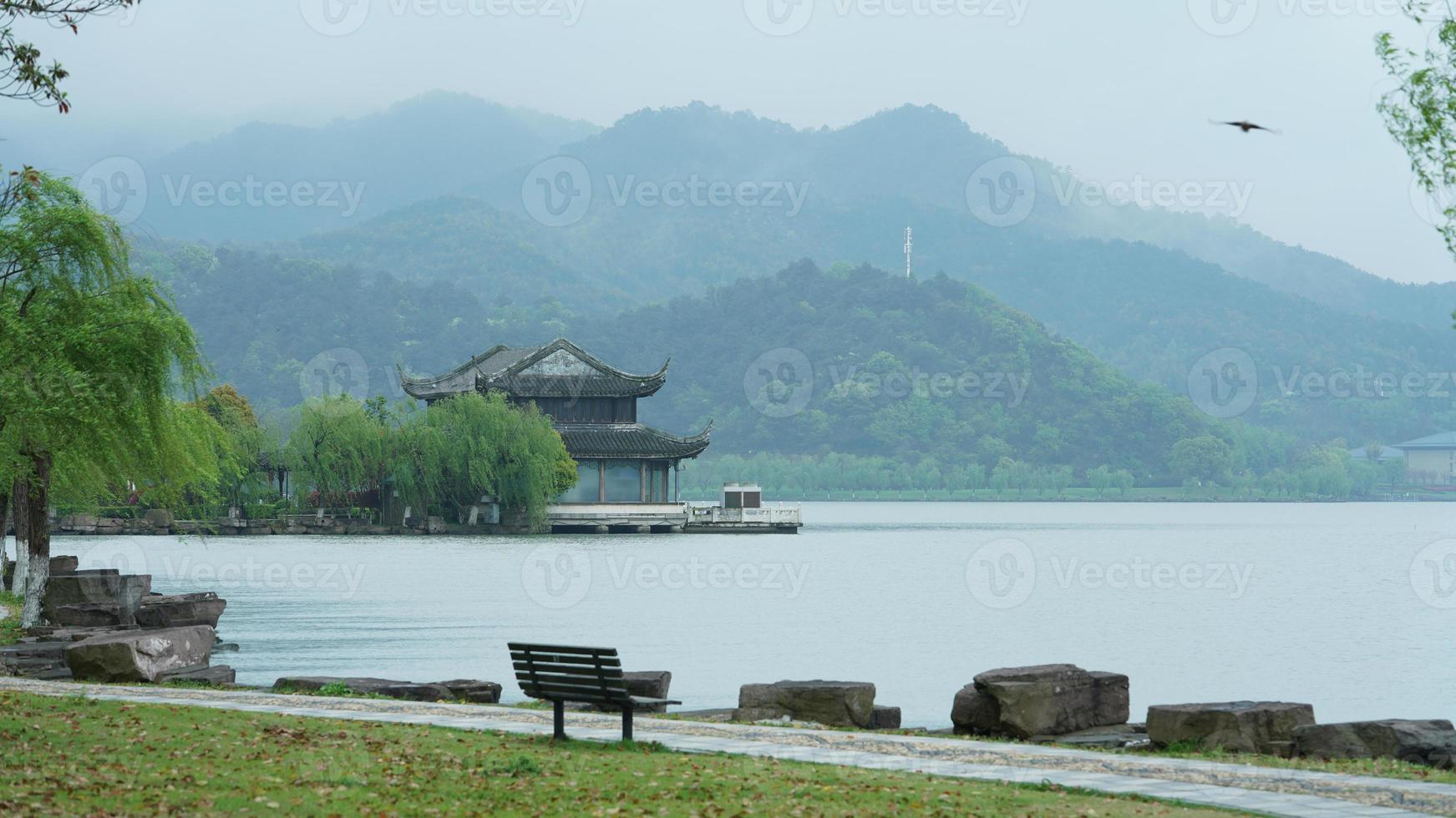 The beautiful lake landscapes in the Hangzhou city of the China in spring with the peaceful lake and fresh green mountains photo
