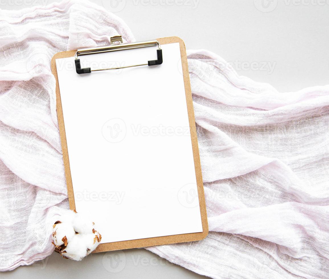 Clipboard and cotton flower photo