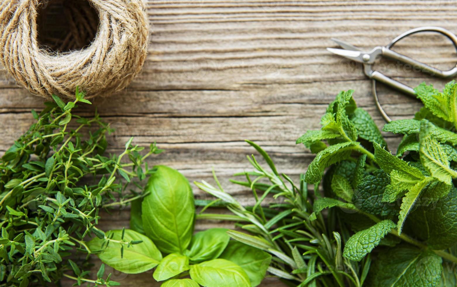 Fresh herbs  on wooden background top view photo