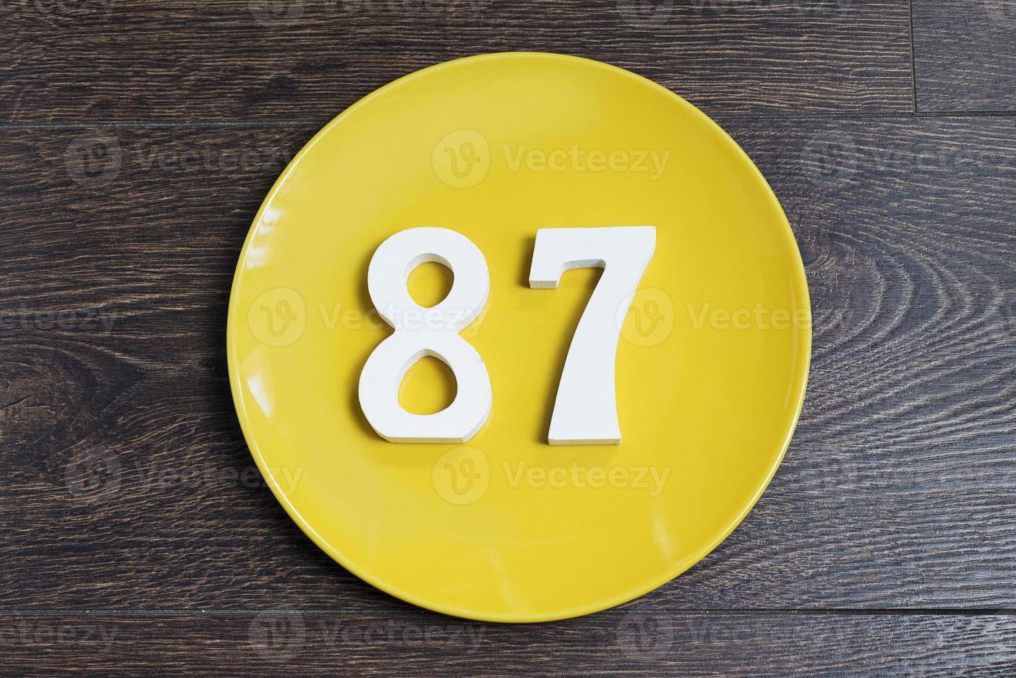 The number eighty-seven on the yellow plate. photo