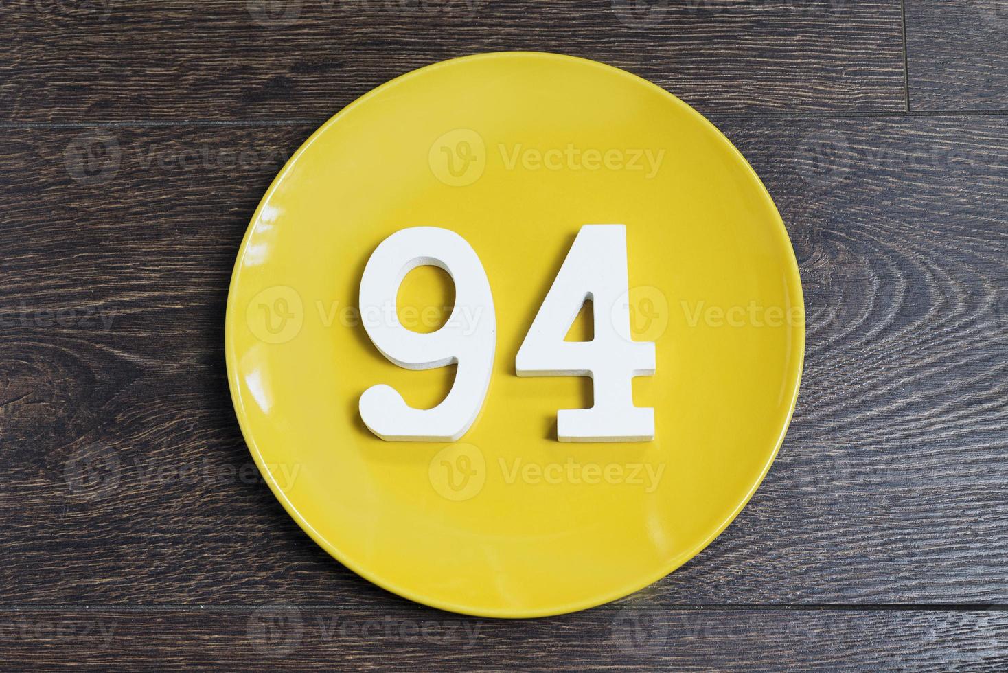 Numeral ninety-four on the yellow plate. photo