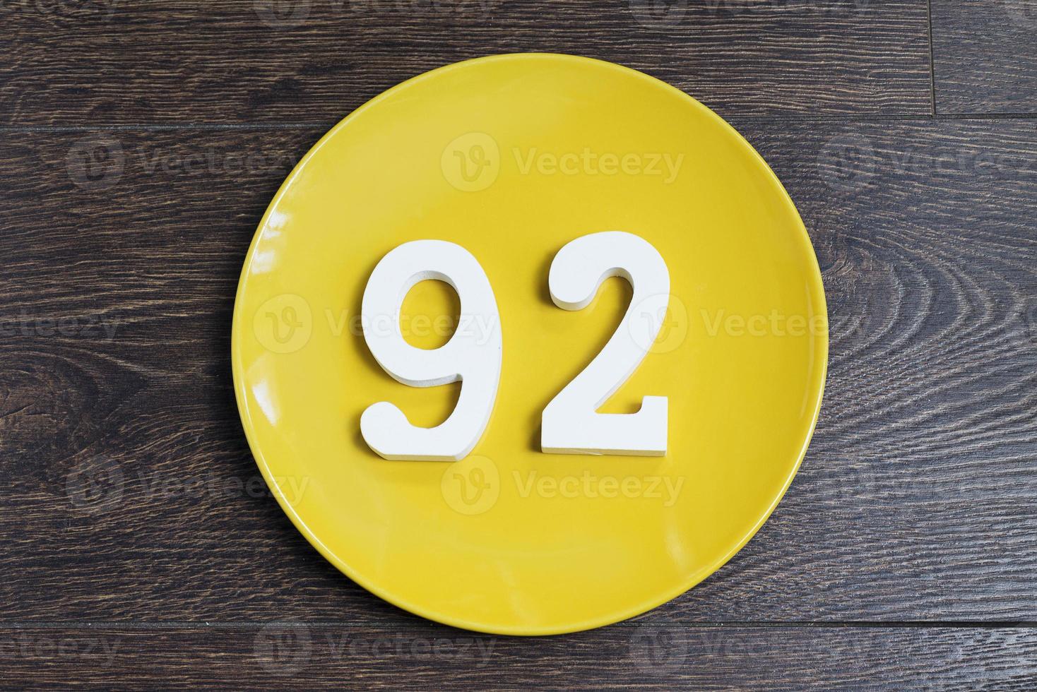 The number ninety-two on the yellow plate. photo